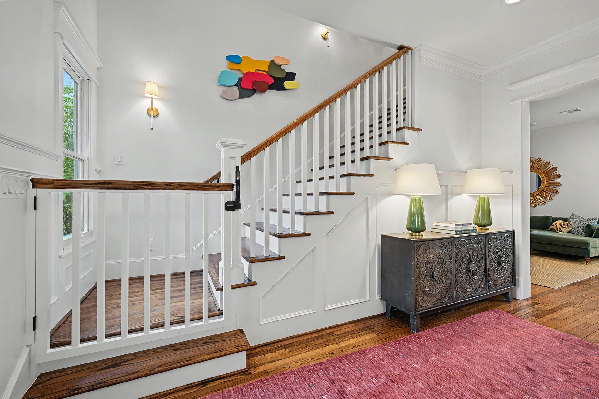 504 W 10th Street, Houston, TX 77008 Fabulous staircase with light sconces along with a kid/dog gate. There's also safety gate at the top of the stairs. One other cool feature is a secret door just to the left of the console piece that's perfect as an extra play spot or for storage.