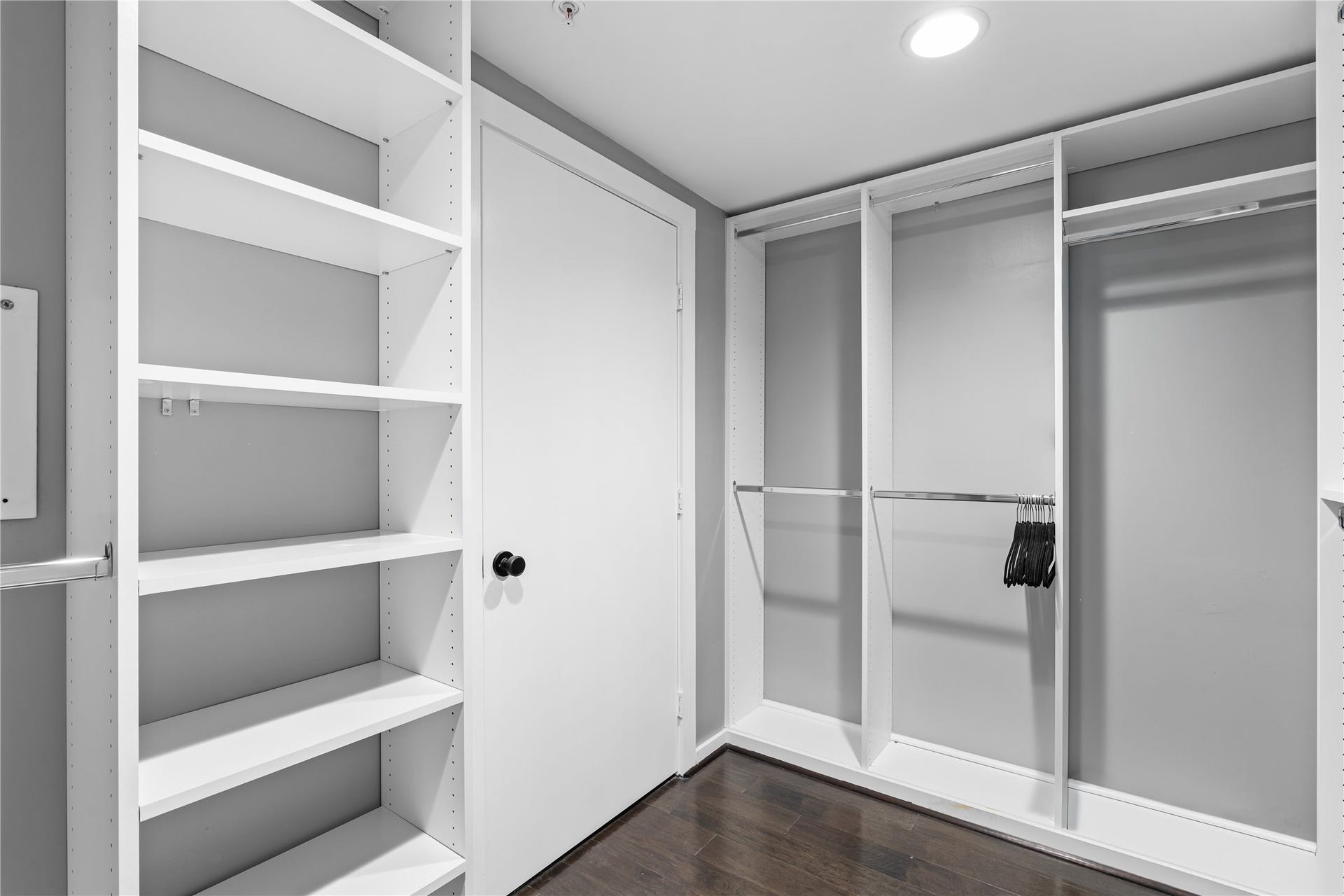 A second view of the primary closet showcases generous built in shelving, hanging space and custom organization designed to maximize storage without sacrificing a clean, streamlined look.