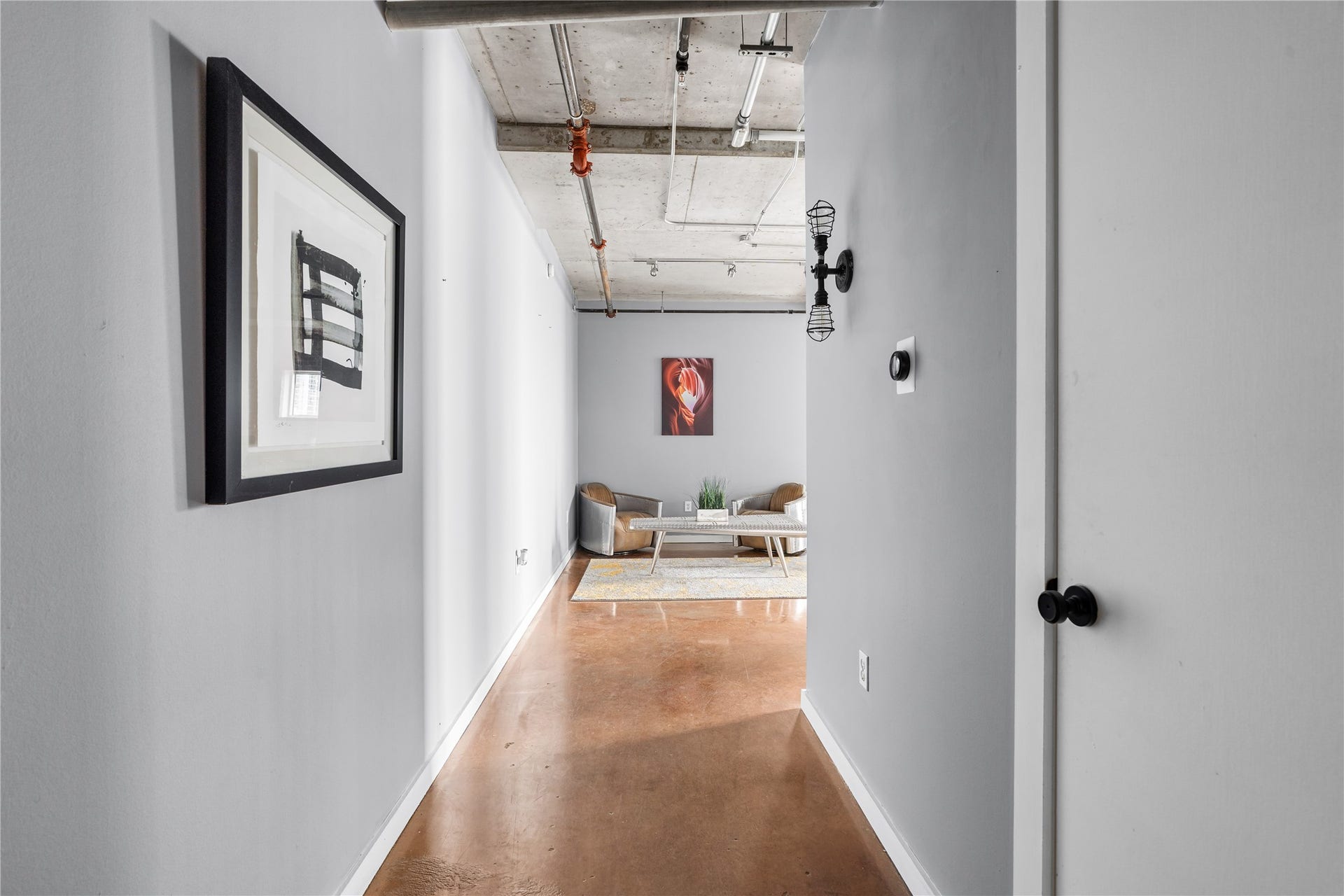 A private entry hall introduces the residence with polished concrete flooring and a clean, gallery inspired approach, offering a subtle introduction to the lofts industrial character.