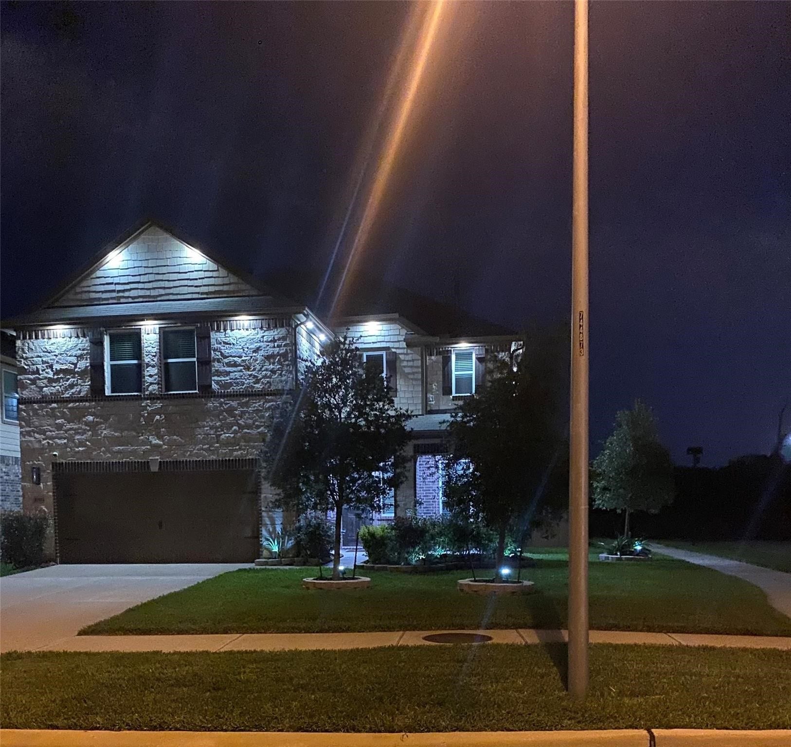 22523 Strathmore Drive, Richmond, TX 77469 Close-up view of this gorgeous home with plenty of lights at night.