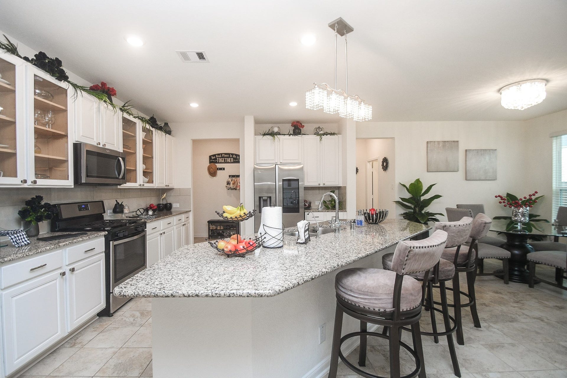 22523 Strathmore Drive, Richmond, TX 77469 This chef's kitchen has a cooking gas range, microwave, plenty of storage and cabinetry, tile backsplash, large granite countertop, and stainless-steel appliances. The refrigerator does not stay.