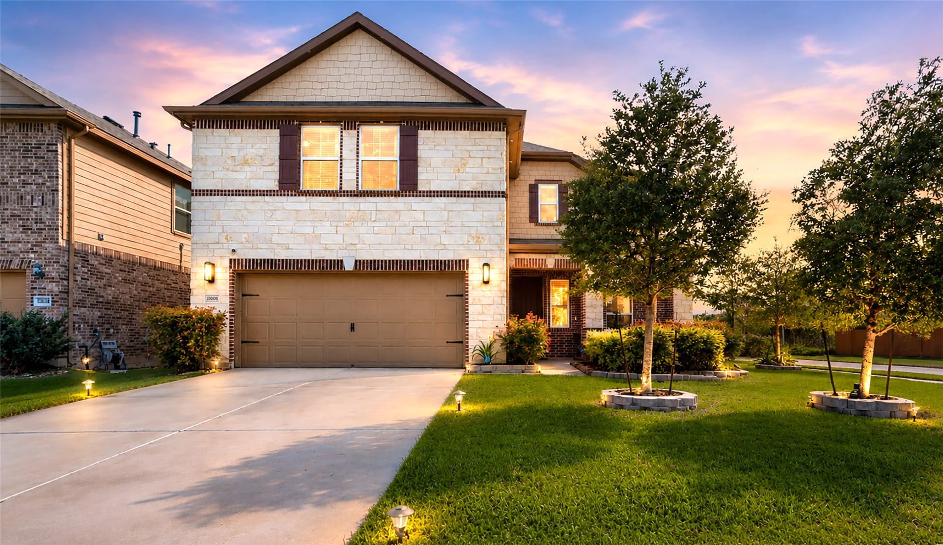 22523 Strathmore Drive, Richmond, TX 77469 This is a two-story house with a modern design, featuring a brick-and-stone facade. It has a two-car garage and a well-maintained front yard with lush green grass and trees. The driveway is spacious, and the neighborhood is quiet and peaceful.