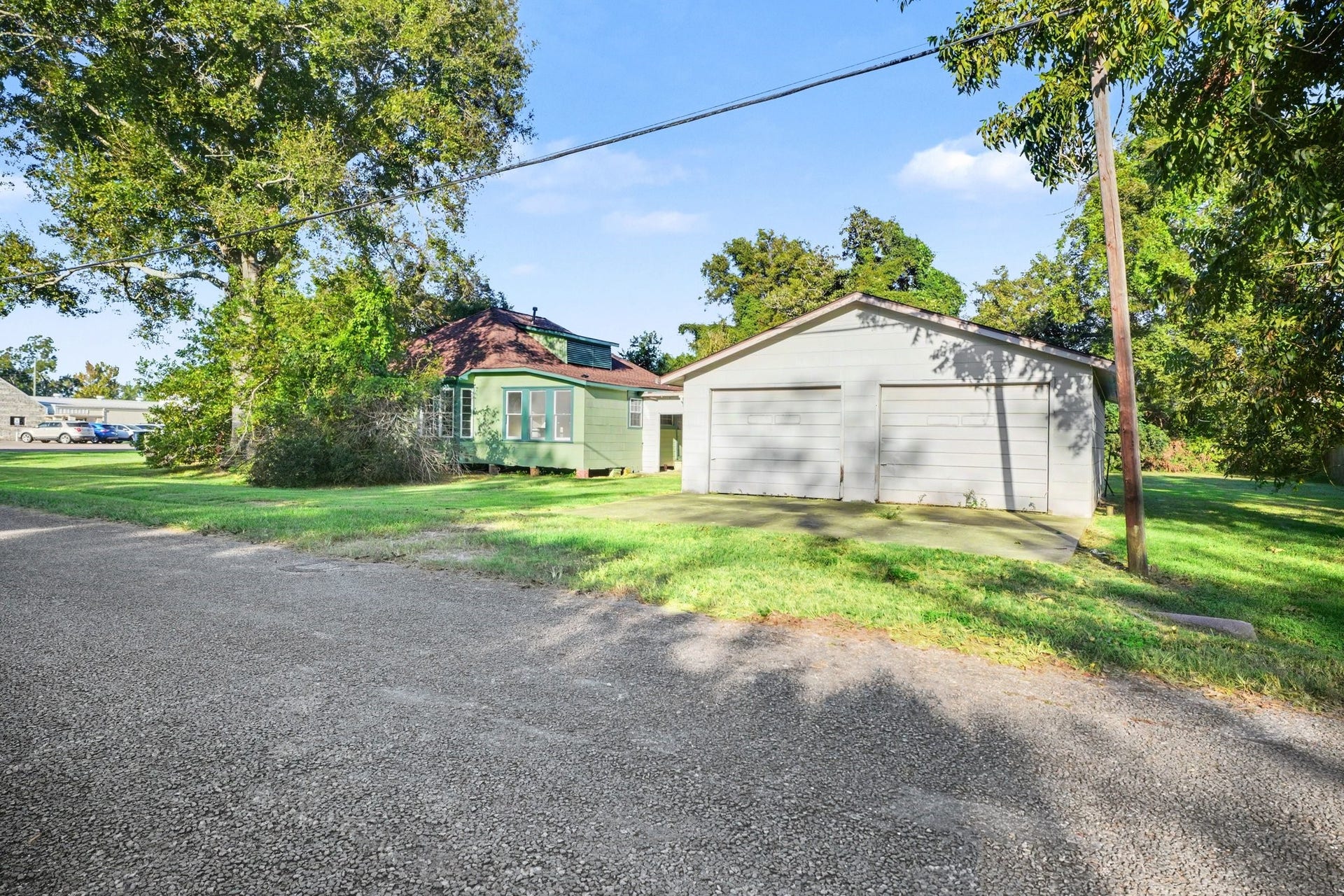 Detached 2 car oversized garage with covered enclosed back patio to connect house with garage for unloading made easy