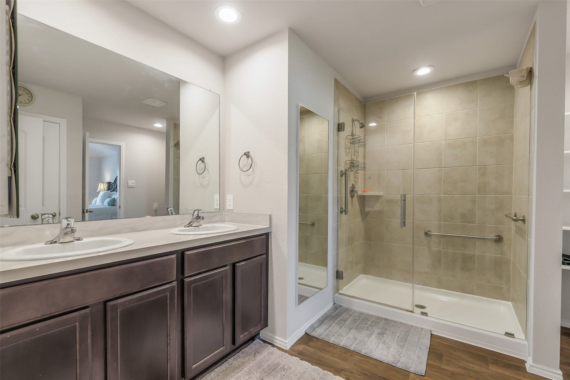21225 Ivy Woods Court, New Caney, TX 77357 Primary ensuite with a large walk-in shower, double vanities and great mirrors.