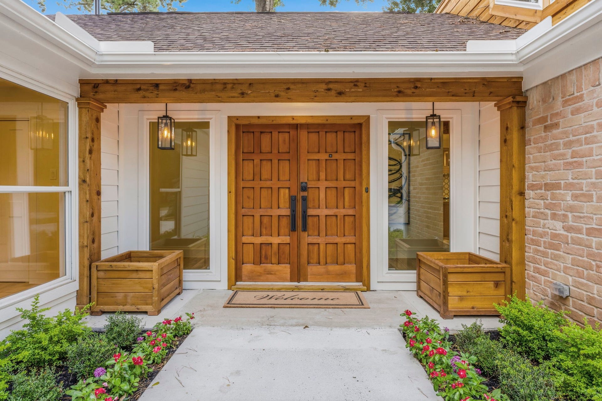 76 Woodhaven Wood Drive, The Woodlands, TX 77380 The original custom double front doors have been beautifully restored and enhanced, preserving the home's character while complementing its modern renovation.