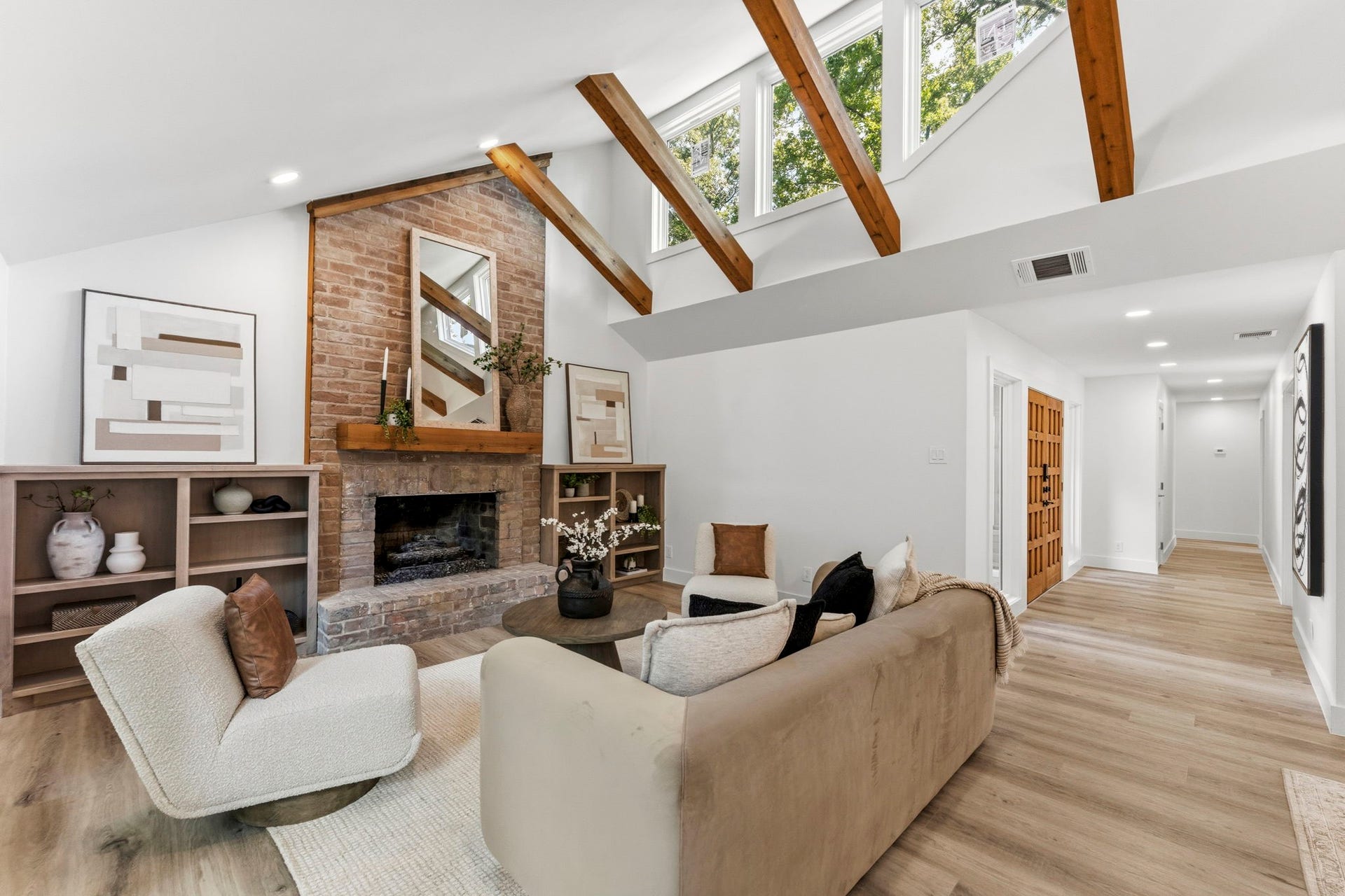 76 Woodhaven Wood Drive, The Woodlands, TX 77380 Open-concept living and dining space highlighted by soaring vaulted ceilings with exposed wood beams and abundant natural light.