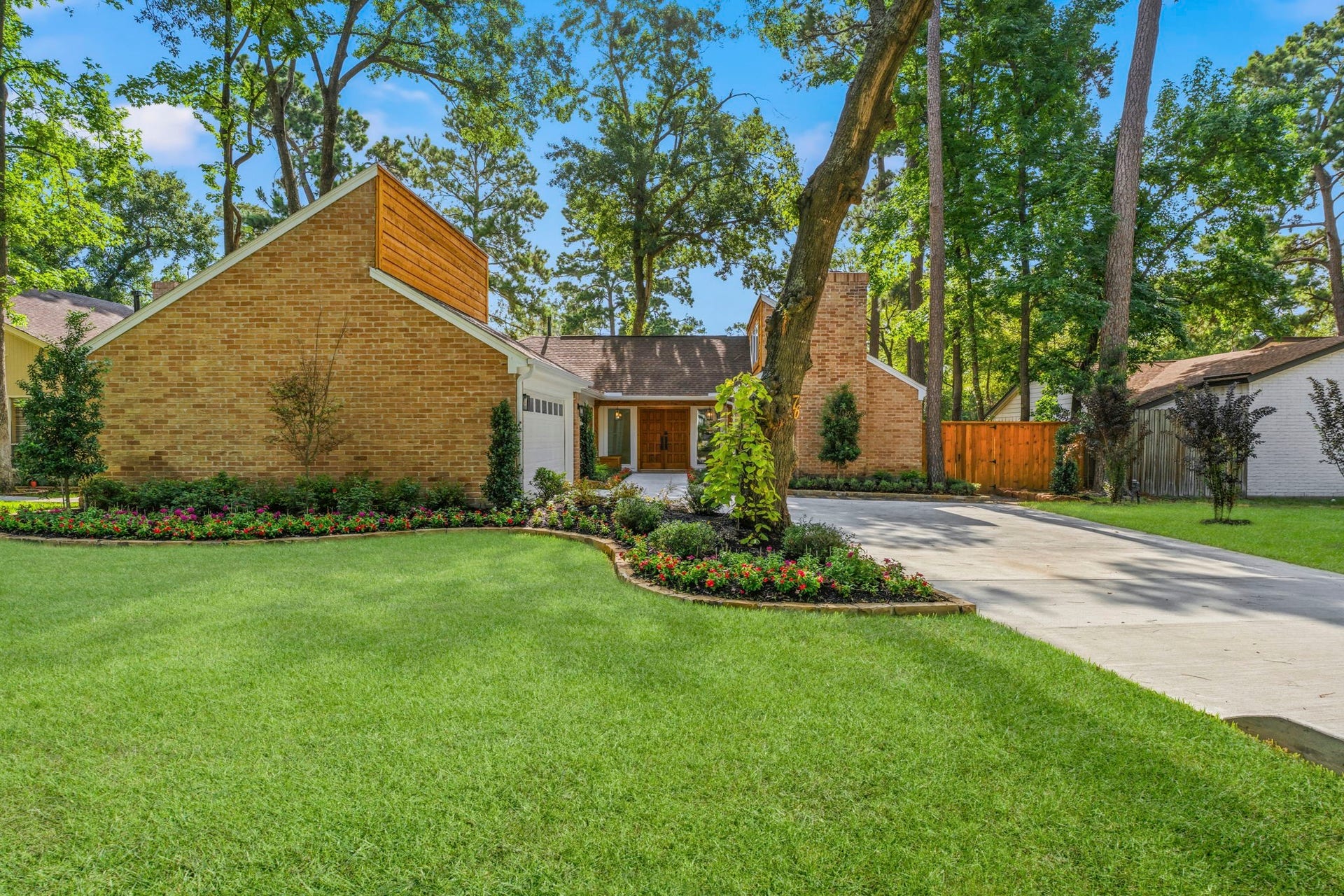 76 Woodhaven Wood Drive, The Woodlands, TX 77380 Professional landscaping, a newly expanded driveway, and timeless brick architecture with modern Hardie siding and cedar accents create exceptional curb appeal.