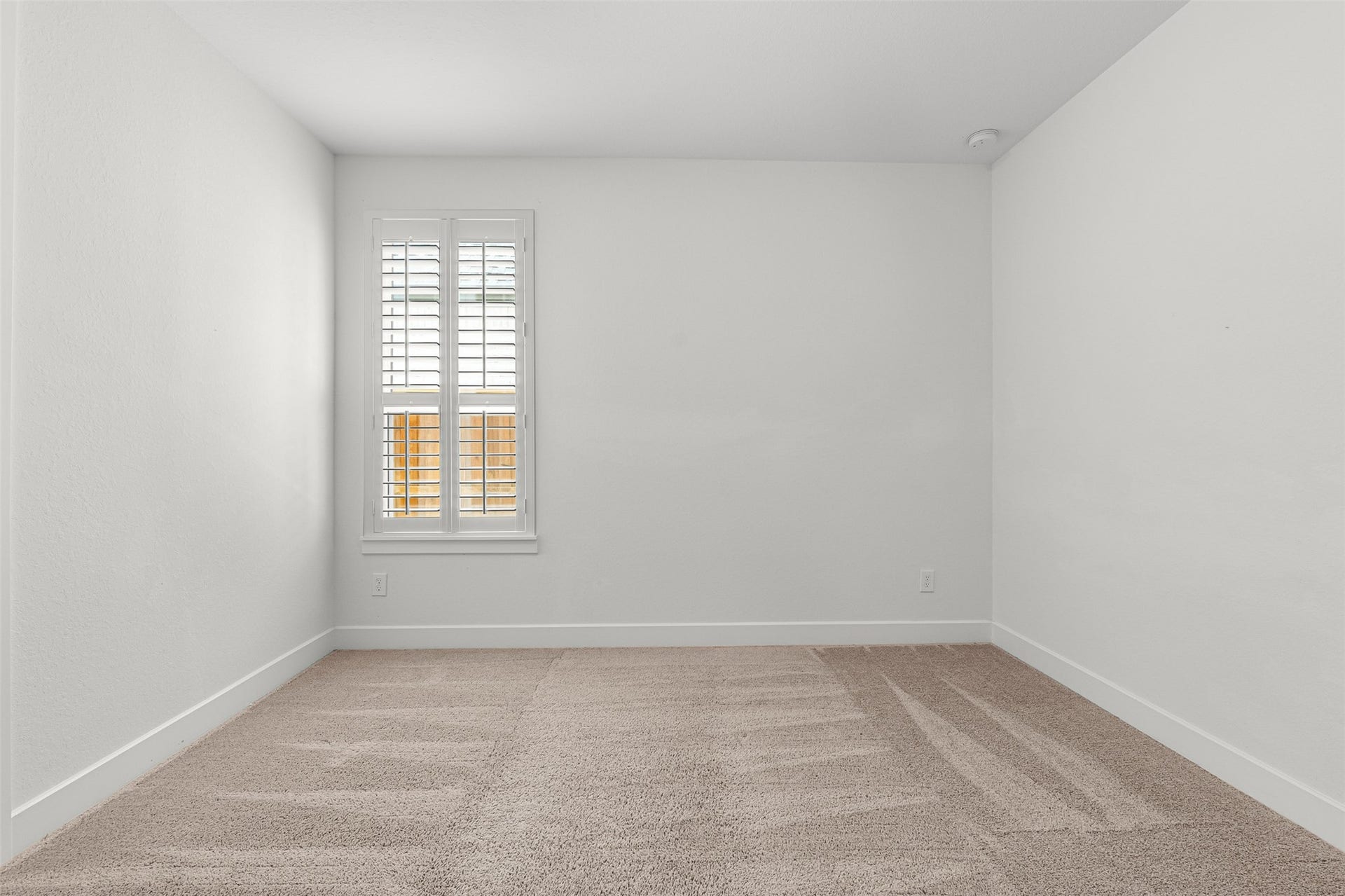 28314 Emerald Bend, Spring, TX 77386 Soft carpet flooring and crisp plantation shutters define this secondary bedroom, offering a clean neutral palette for guests or personalized decor.