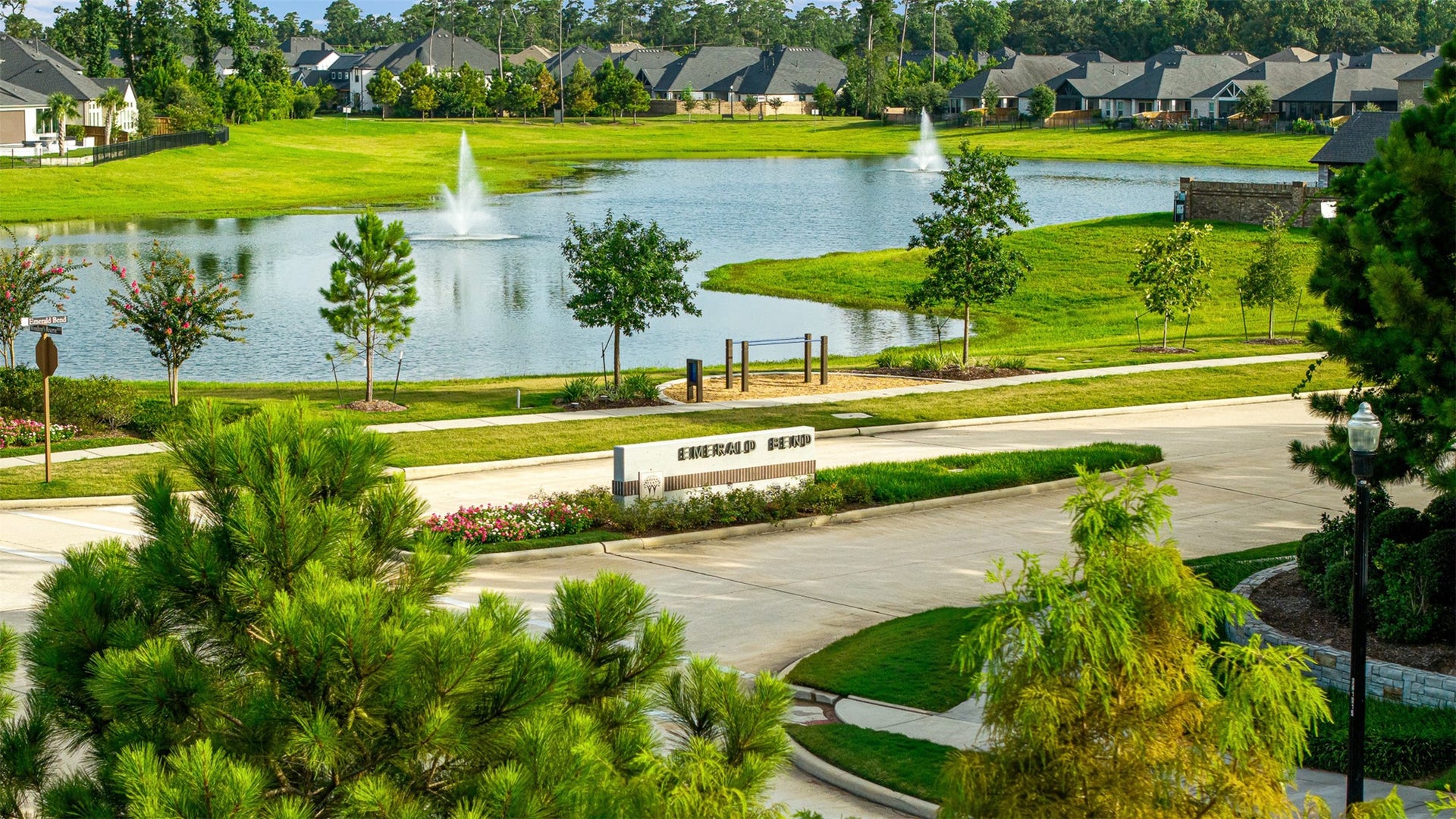 28314 Emerald Bend, Spring, TX 77386 Fountains dance in the serene catch-and-release pond, surrounded by lush green space and scenic walking paths within this amenity-rich neighborhood.