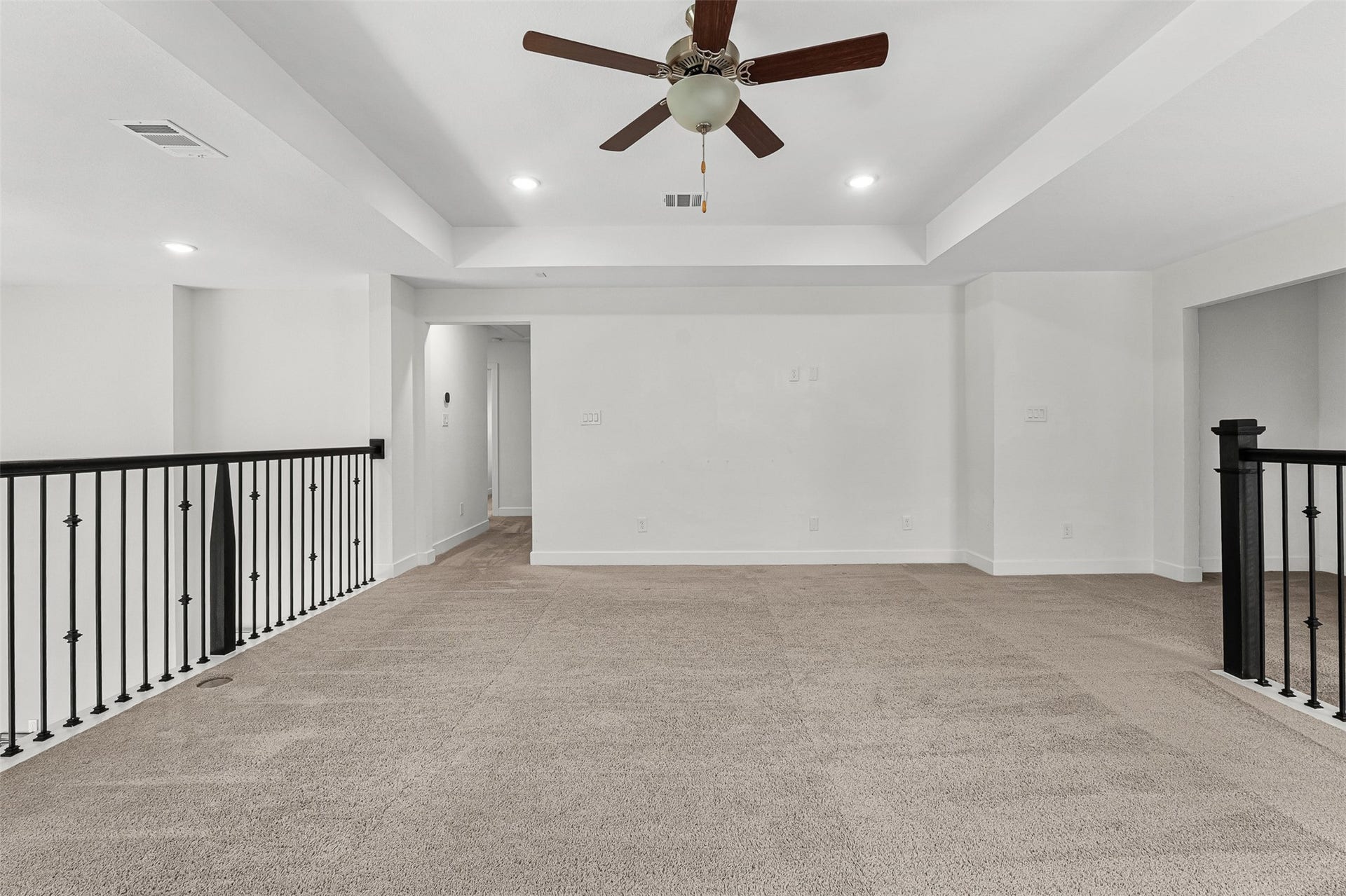 28314 Emerald Bend, Spring, TX 77386 Perched above the first floor, this versatile flex space features plush carpet, a tray ceiling, and a dark wrought-iron railing overlook. Recessed lighting illuminates the open layout, while a central doorway leads to adjoining secondary bedrooms.