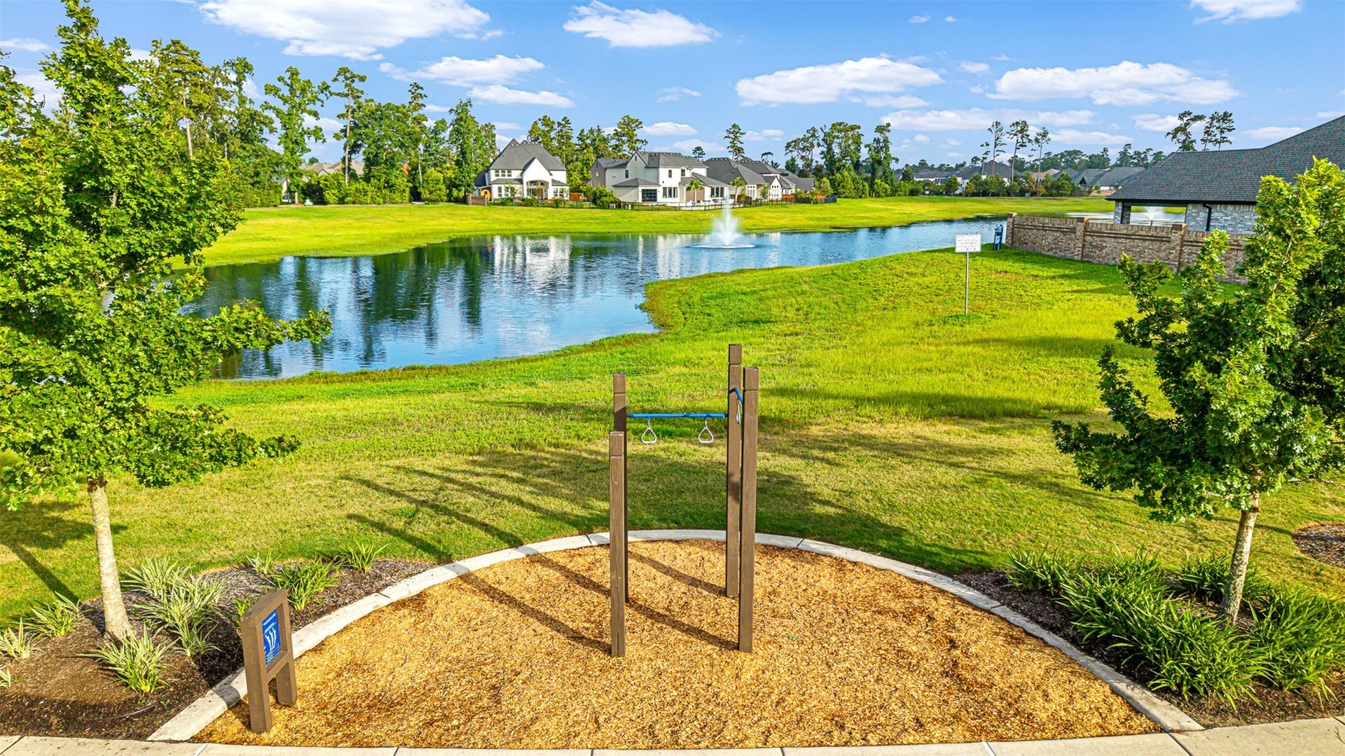 28314 Emerald Bend, Spring, TX 77386 An outdoor fitness station sits along a paved trail overlooking a tranquil catch-and-release pond with a fountain in this amenity-rich neighborhood.