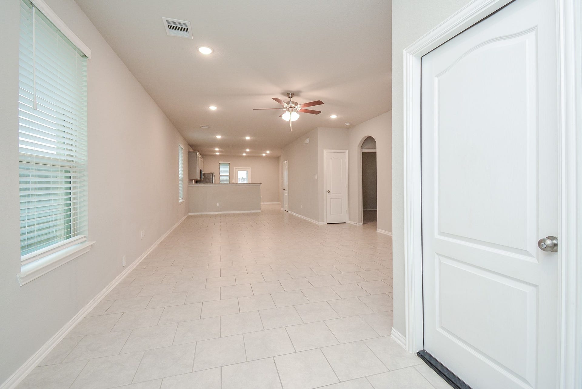 7450 French Quarter Court, Fulshear, TX 77441 The beauty and versatility of the open floor plan is appreciated in this view from the front door, straight back to the patio door!