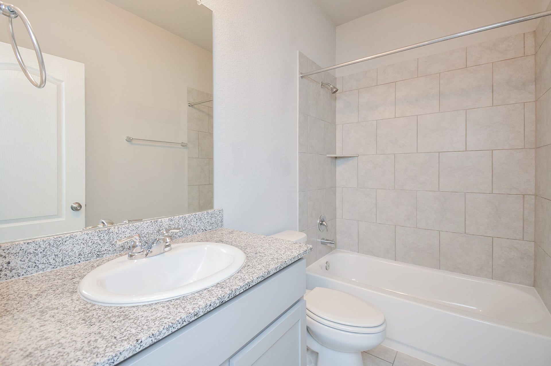 7450 French Quarter Court, Fulshear, TX 77441 Don't you love the repeated use of giant tile in the combined shower/bathtub in the 2nd full bathroom?