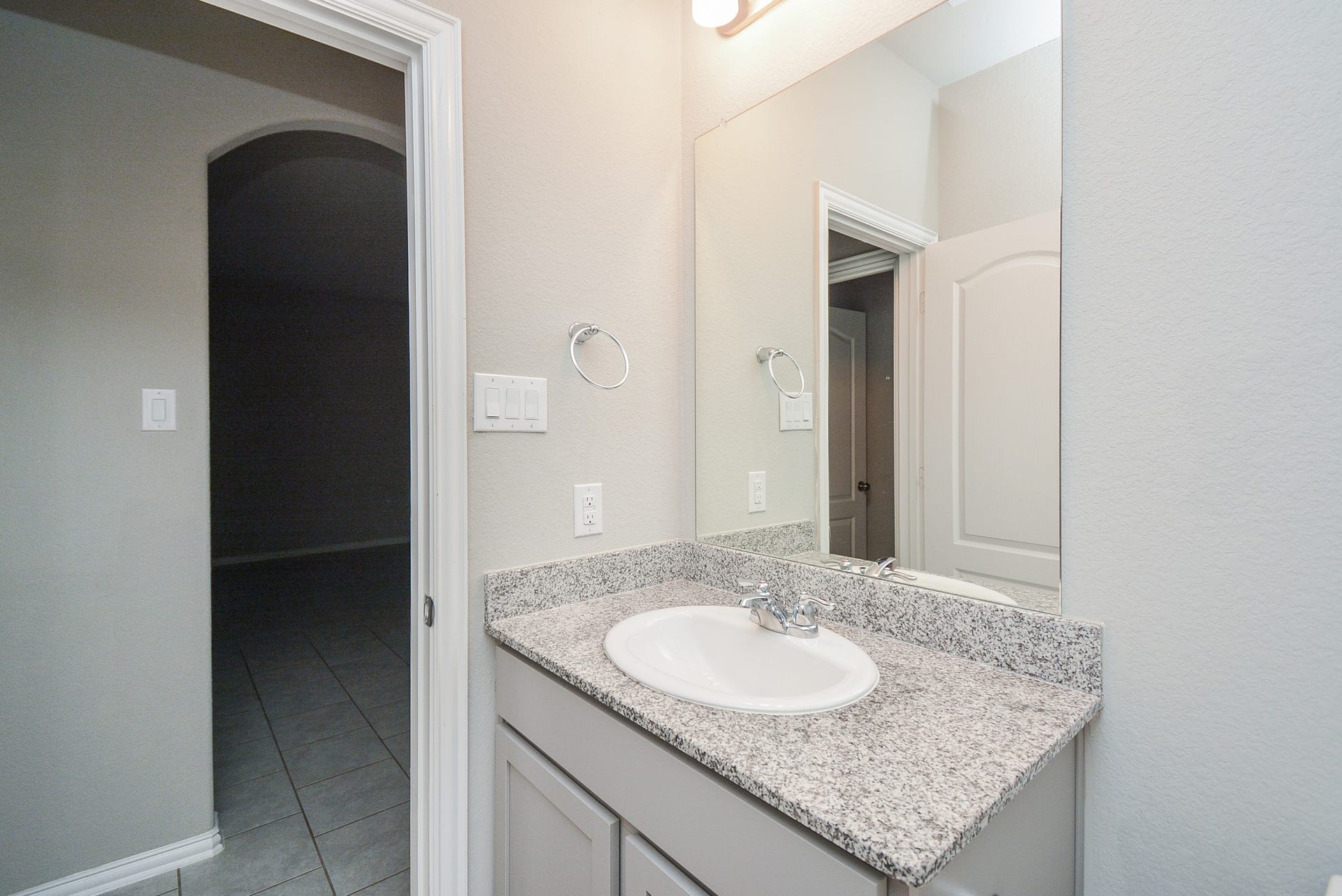 7450 French Quarter Court, Fulshear, TX 77441 The second bathroom sits off the main living area, left.