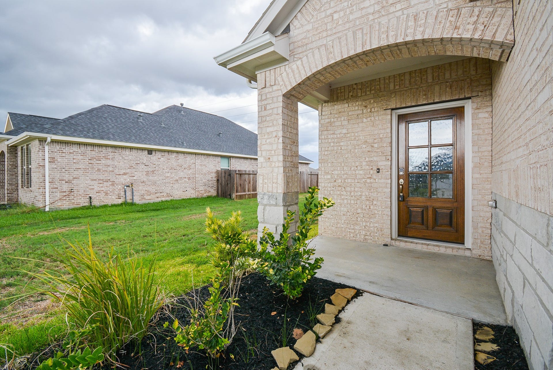 7450 French Quarter Court, Fulshear, TX 77441 A generous planting bed offers a green welcome as you walk to the covered main entrance, which shares a sizeable front porch.