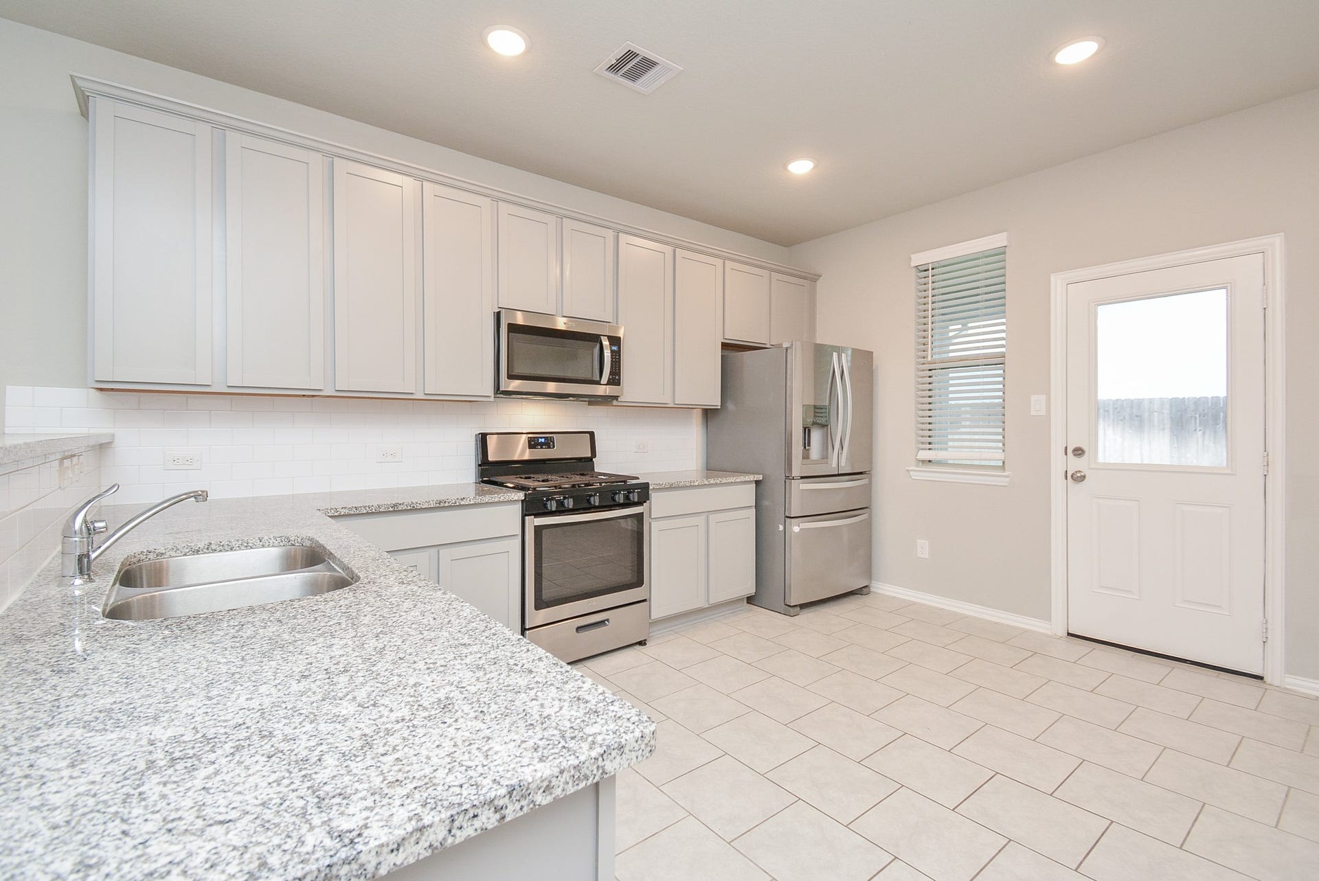 7450 French Quarter Court, Fulshear, TX 77441 The easily workable kitchen features creamy granite countertops, everywhere, with good storage cabinetry, shining tile backsplash and stainless steel appliances.