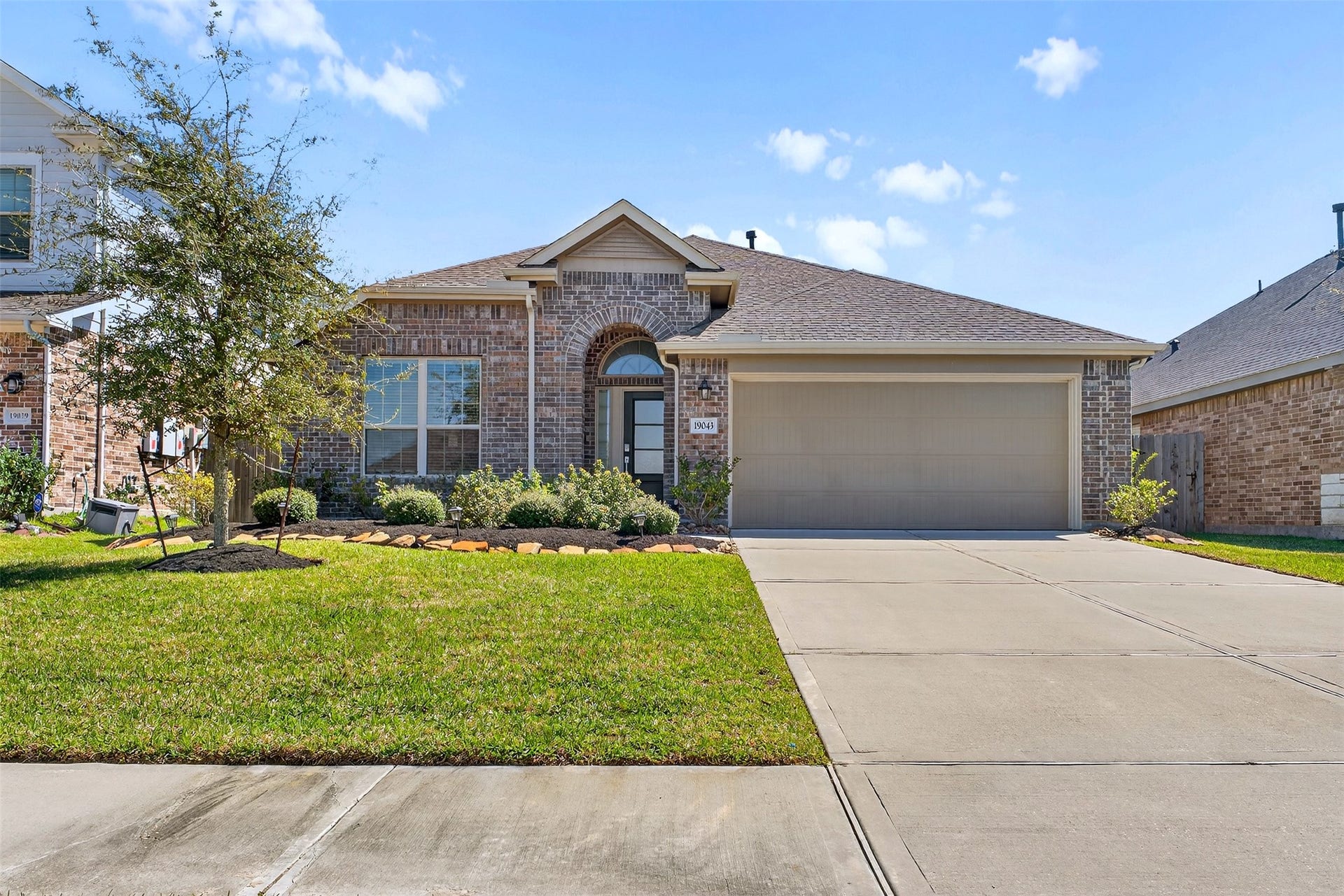 Welcome home, 19043 Pinewood Grove Trail. Freshly manicured and well-maintained lawn year round.