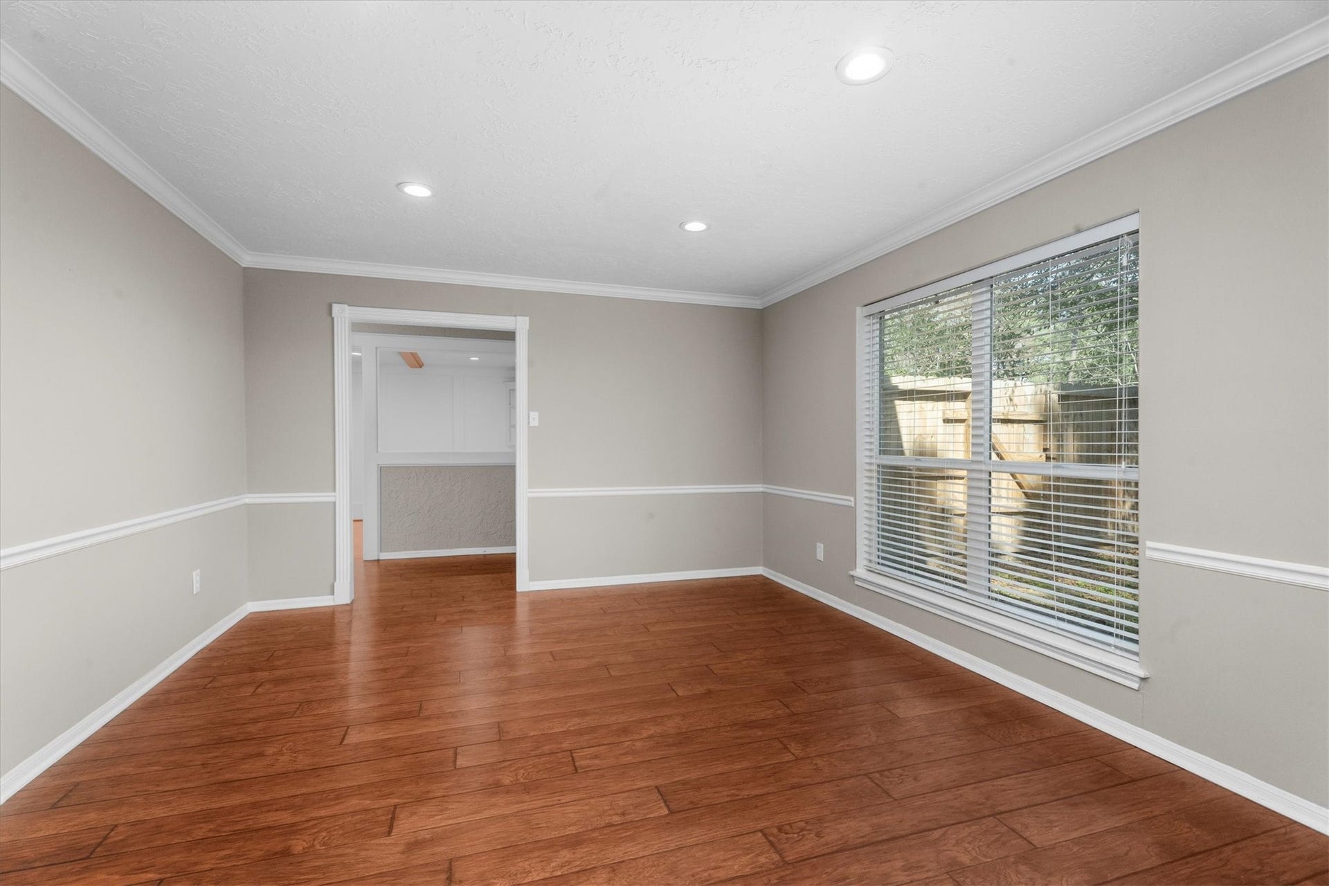 5939 Havenwoods Drive, Houston, TX 77066 Living Room with chair rail, crown molding and updated flooring