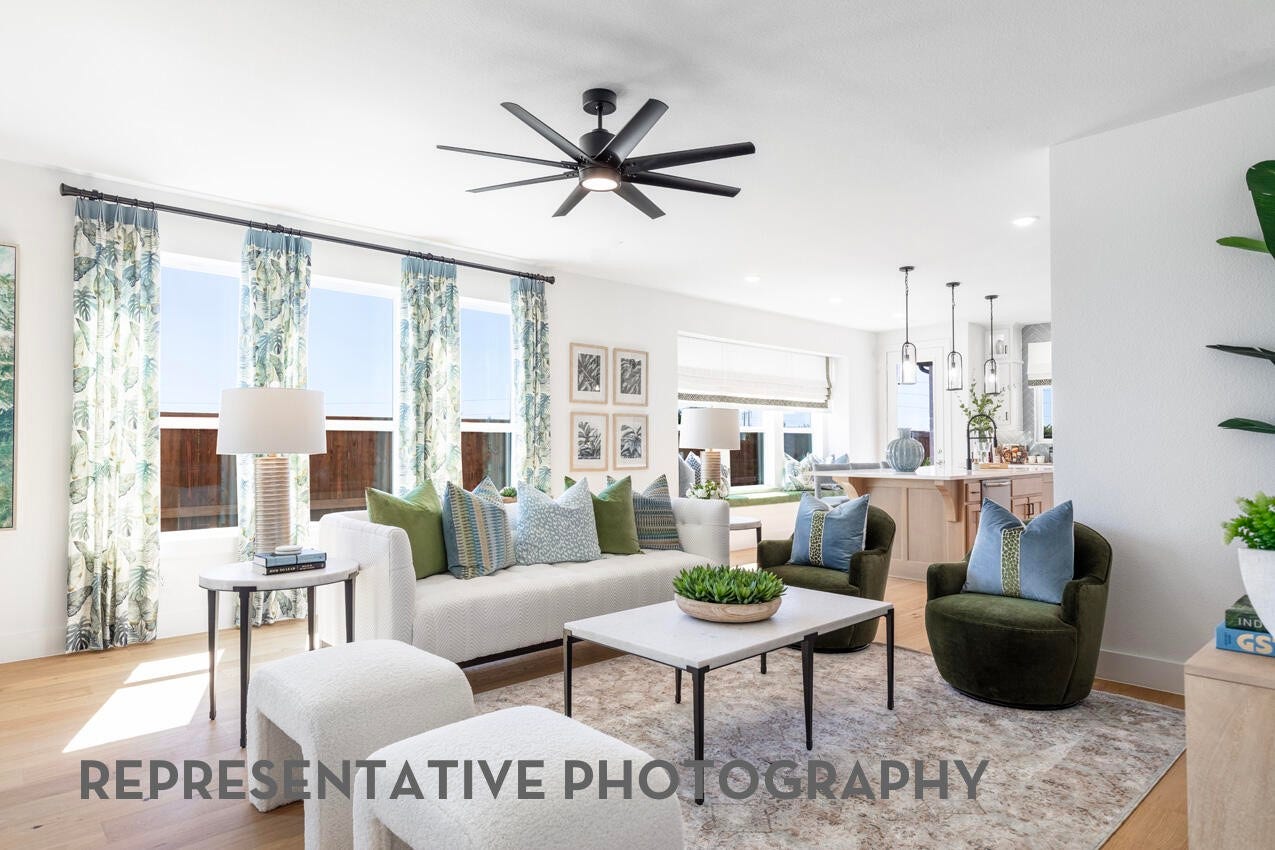 A family room with high ceilings and large windows creates a bright, open space that's perfect for gathering and spending time together.