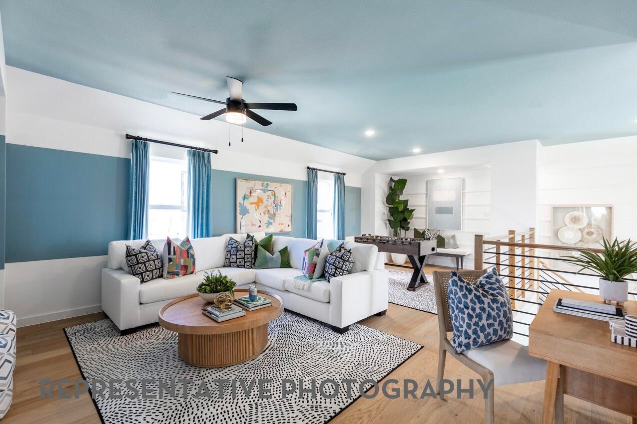 A game room or loft with windows and an open view to the dining room creates a bright, connected space idea for entertaining and casual living.
