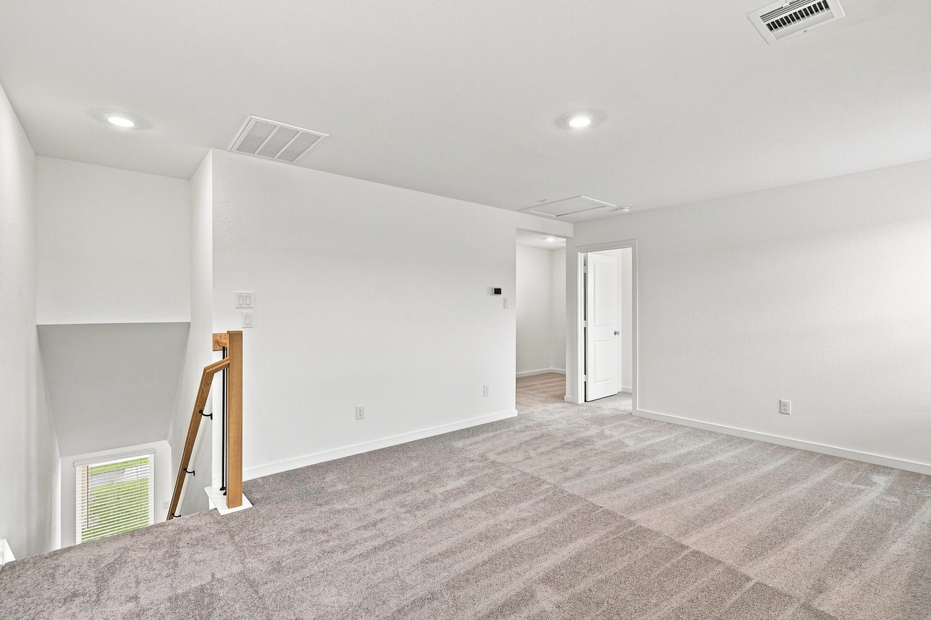 139 High Life Crossing, Richmond, TX 77469 This open loft area sits at the top of the stairs, offering easy access to the secondary bedrooms and serving as a natural gathering space separate from the downstairs living areas.