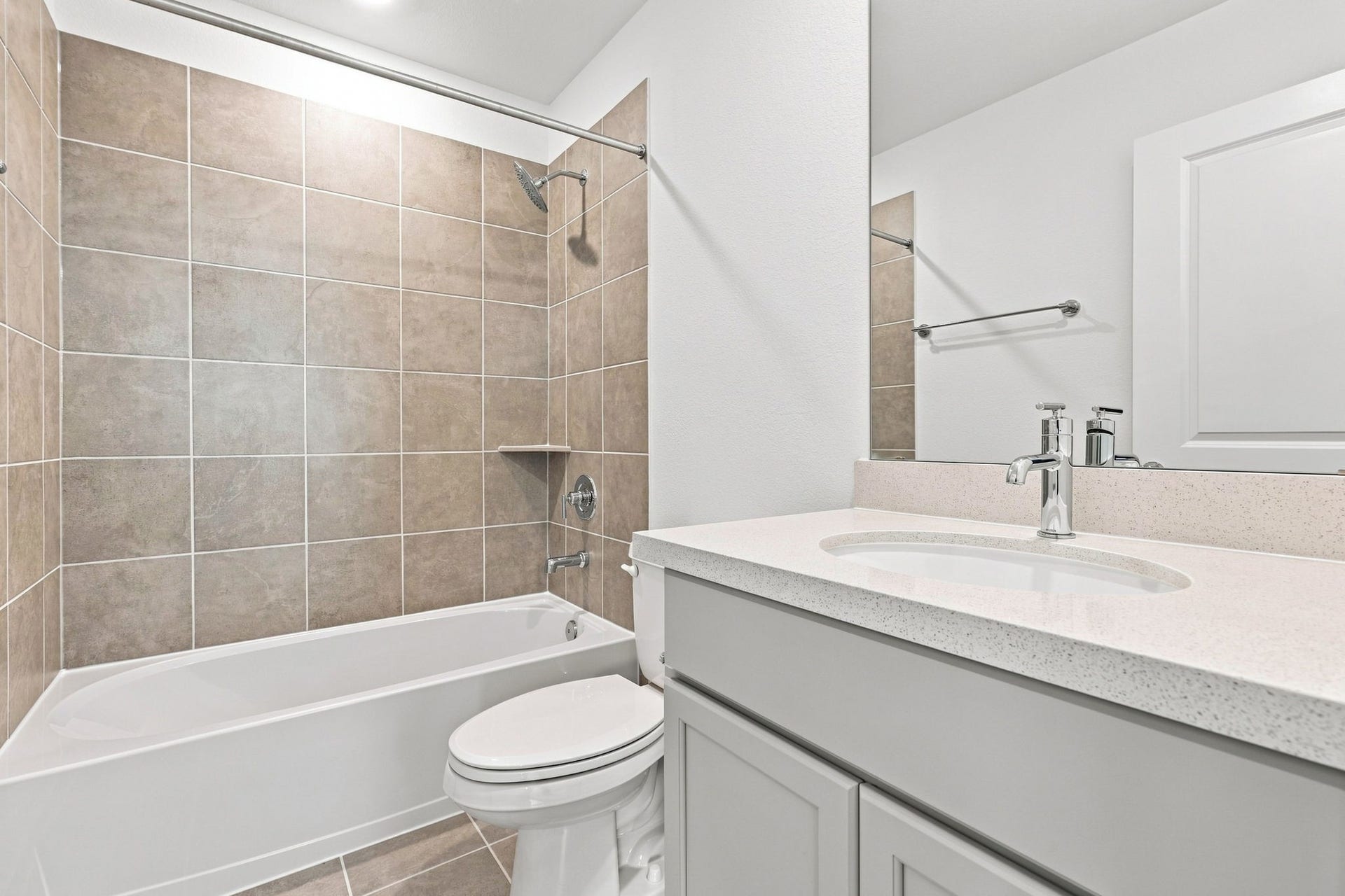 139 High Life Crossing, Richmond, TX 77469 Full 3rd bathroom featuring a tub/shower combo with floor-to-ceiling tile surround, a quartz-topped vanity, and modern chrome fixtures.