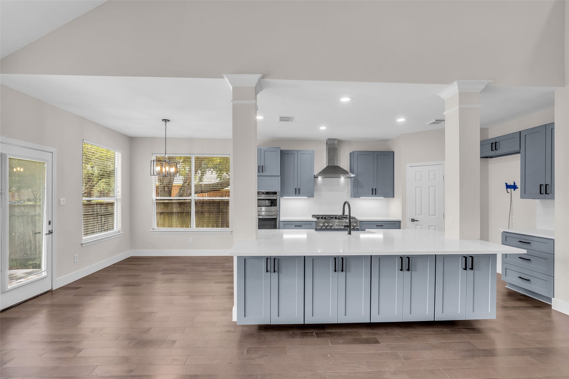 22002 Madera Canyon Court, Richmond, TX 77469 Spacious open-concept kitchen with sleek cabinetry, a large central island, modern stainless steel appliances, and abundant natural light from generous windows.