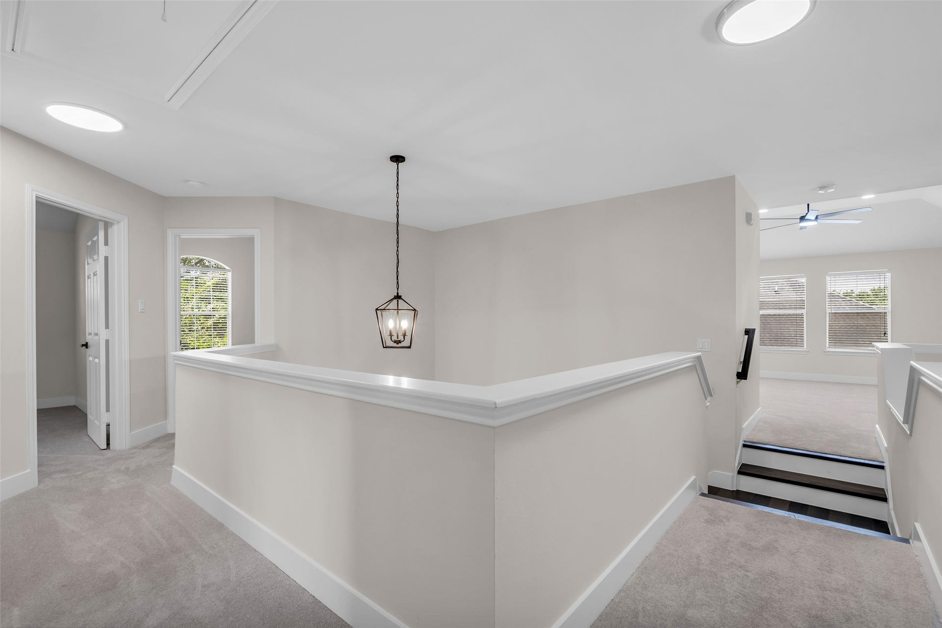 22002 Madera Canyon Court, Richmond, TX 77469 Bright, open hallway with modern lighting, plush carpeting, and access to multiple rooms, creating a spacious and inviting upper level.