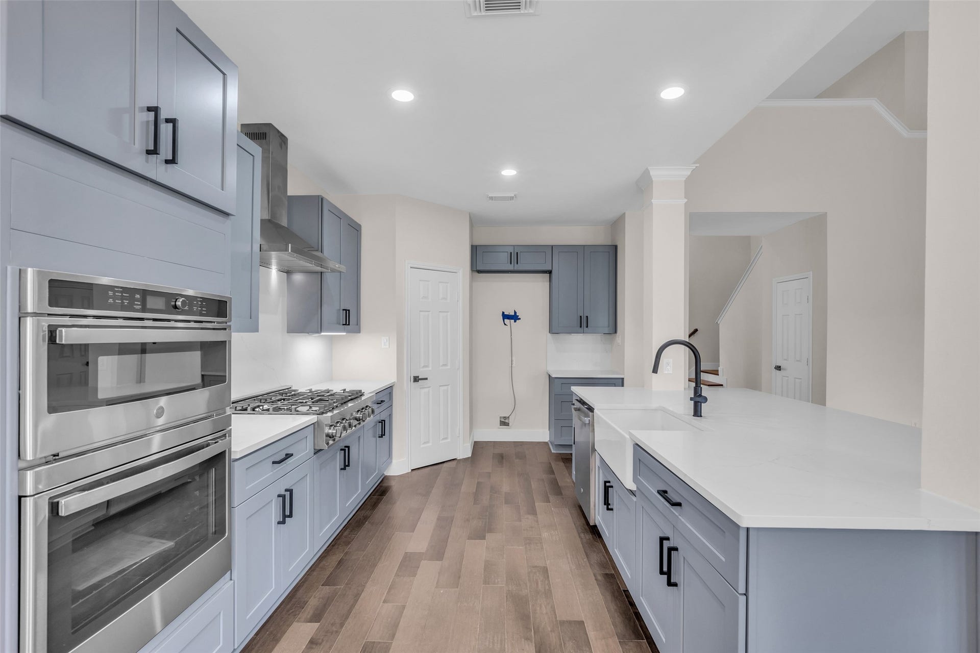 22002 Madera Canyon Court, Richmond, TX 77469 Modern kitchen with sleek cabinetry, stainless steel appliances, and a spacious white countertop, perfect for culinary enthusiasts.