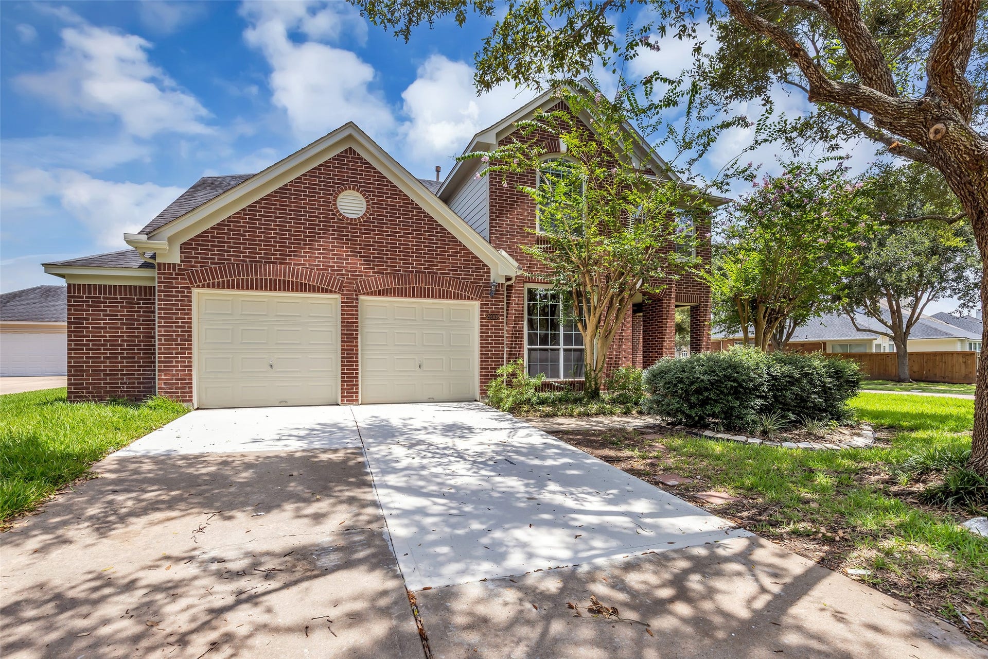 22002 Madera Canyon Court, Richmond, TX 77469 Charming brick home with a two-car garage and lush landscaping, set in a peaceful neighborhood.