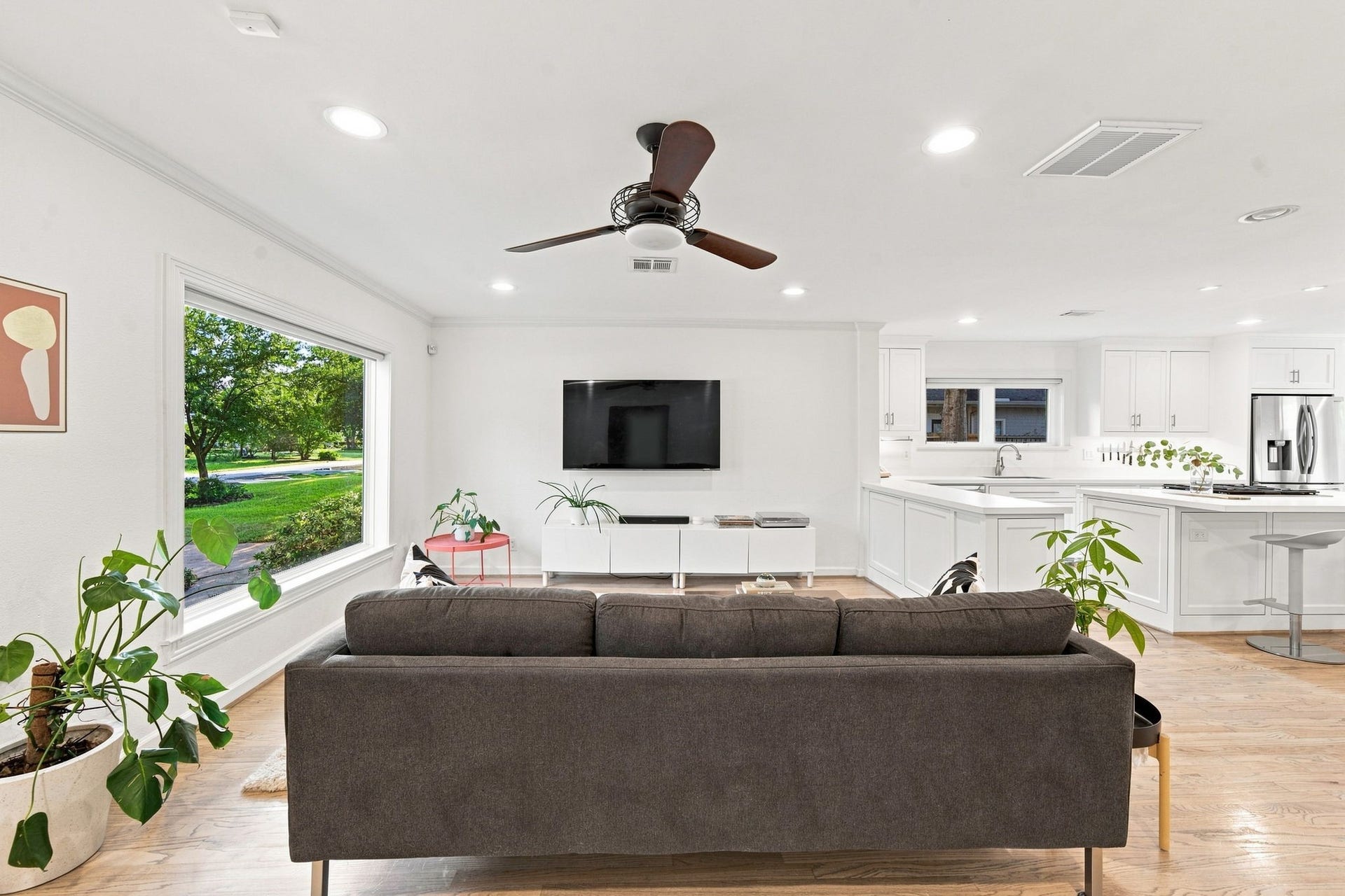 Living room open to the kitchen. Refinished hardwoods and light from the double-pane windows.