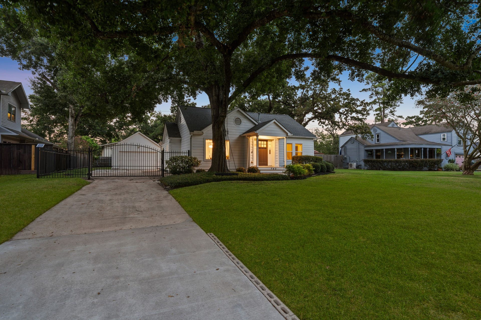 Garden Oaks original on an 11,820 sqft lot under a mature oak. Long driveway, deep front lawn.