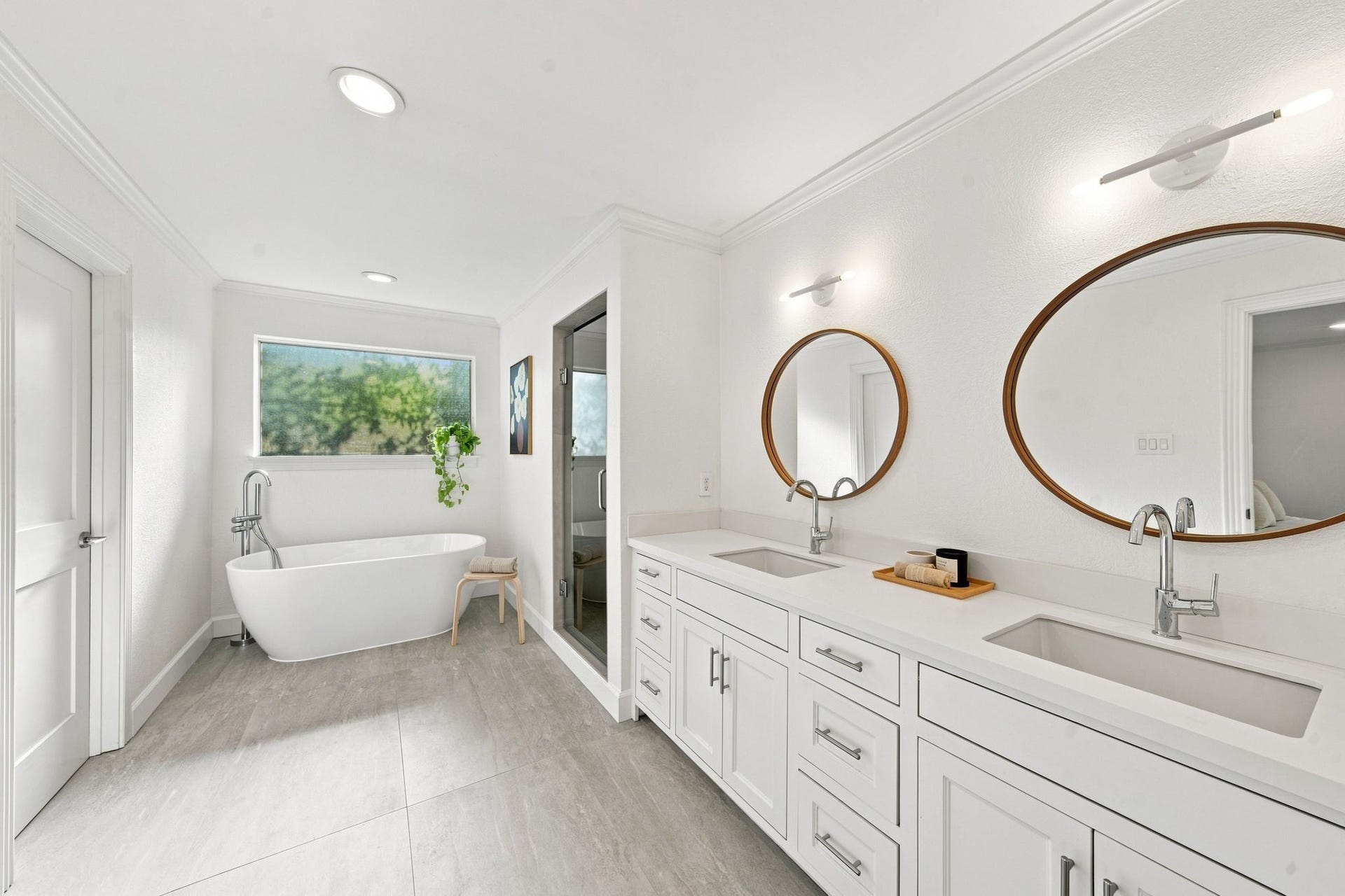 Primary bath remodeled 2026: freestanding tub, double vanity, tile floors, walk-in closet.