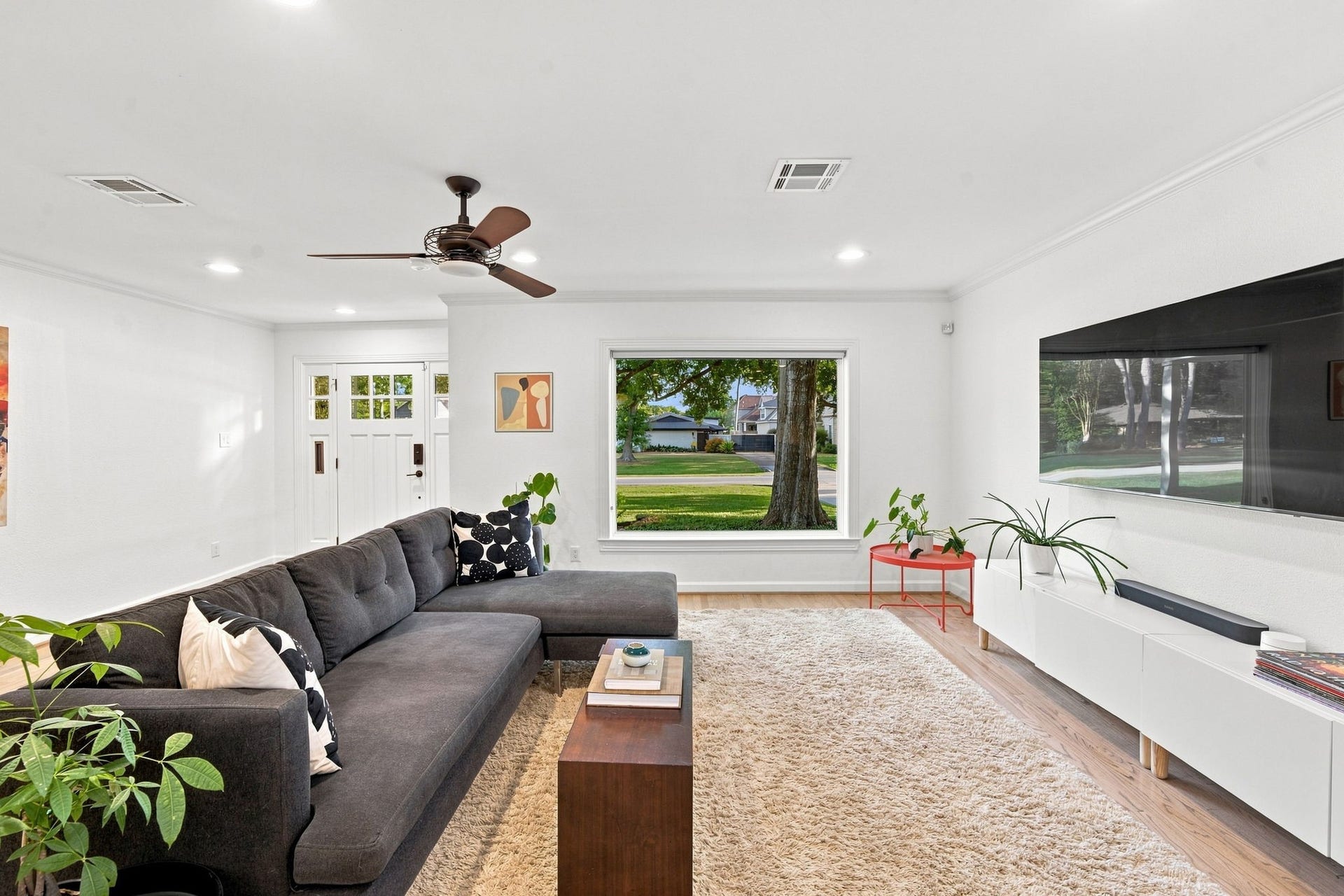 Living room with a view to the front lawn and the oak. Ceiling fan, refinished hardwoods.