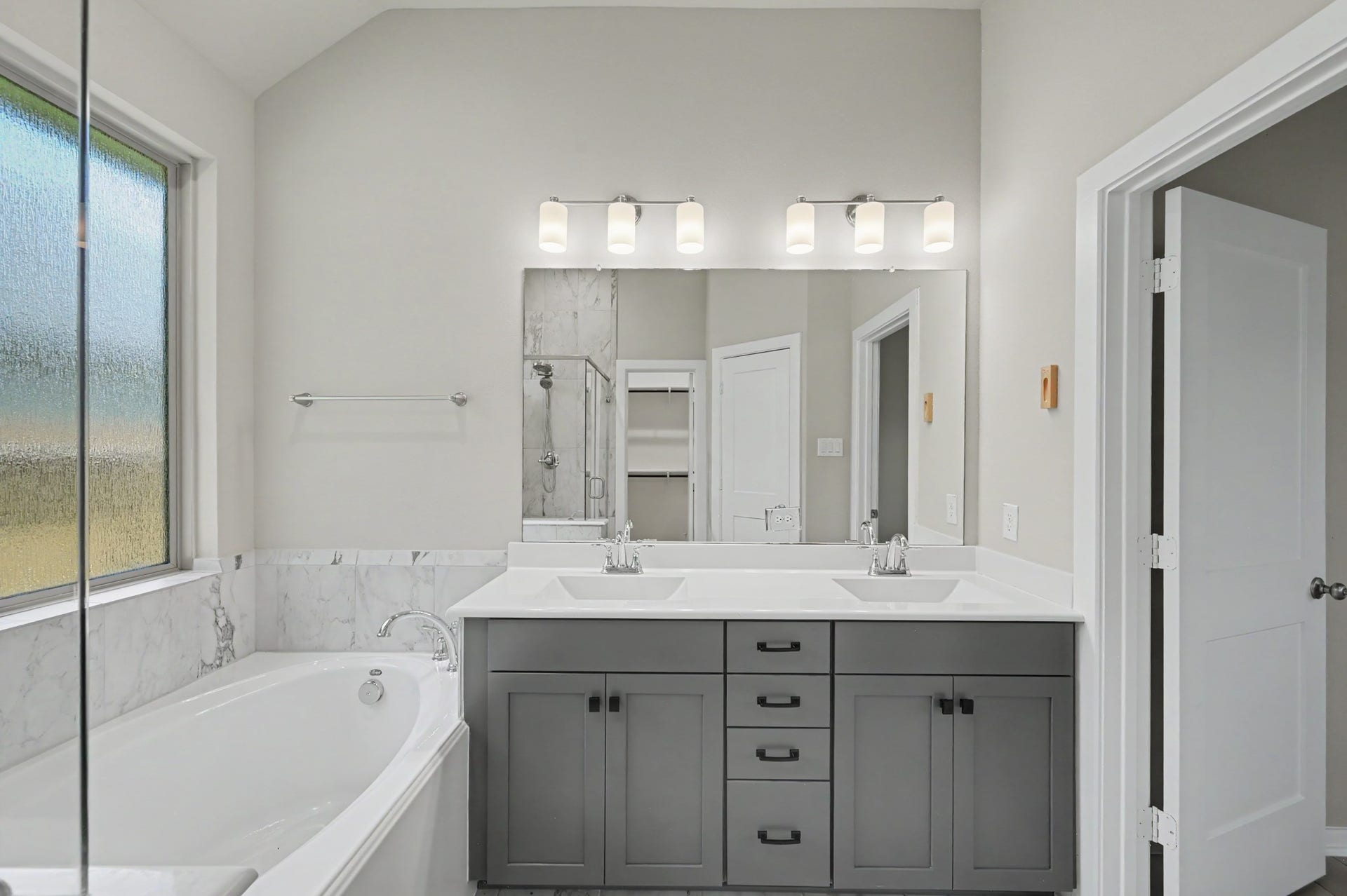 Luxurious primary bath with dual sinks.