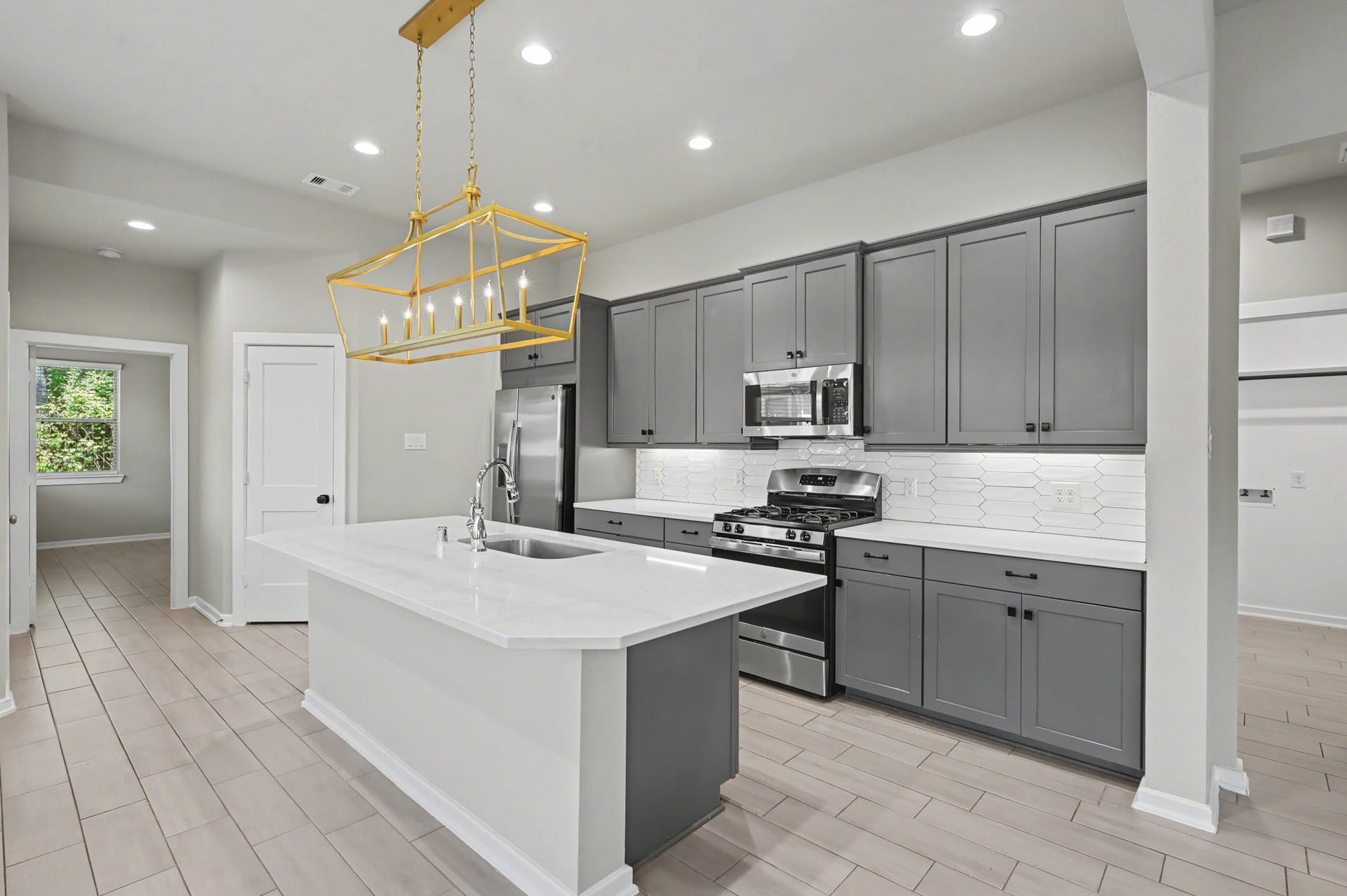 Huge kitchen island is a great space to eat & entertain. Under cabinet lights and custom finishes.