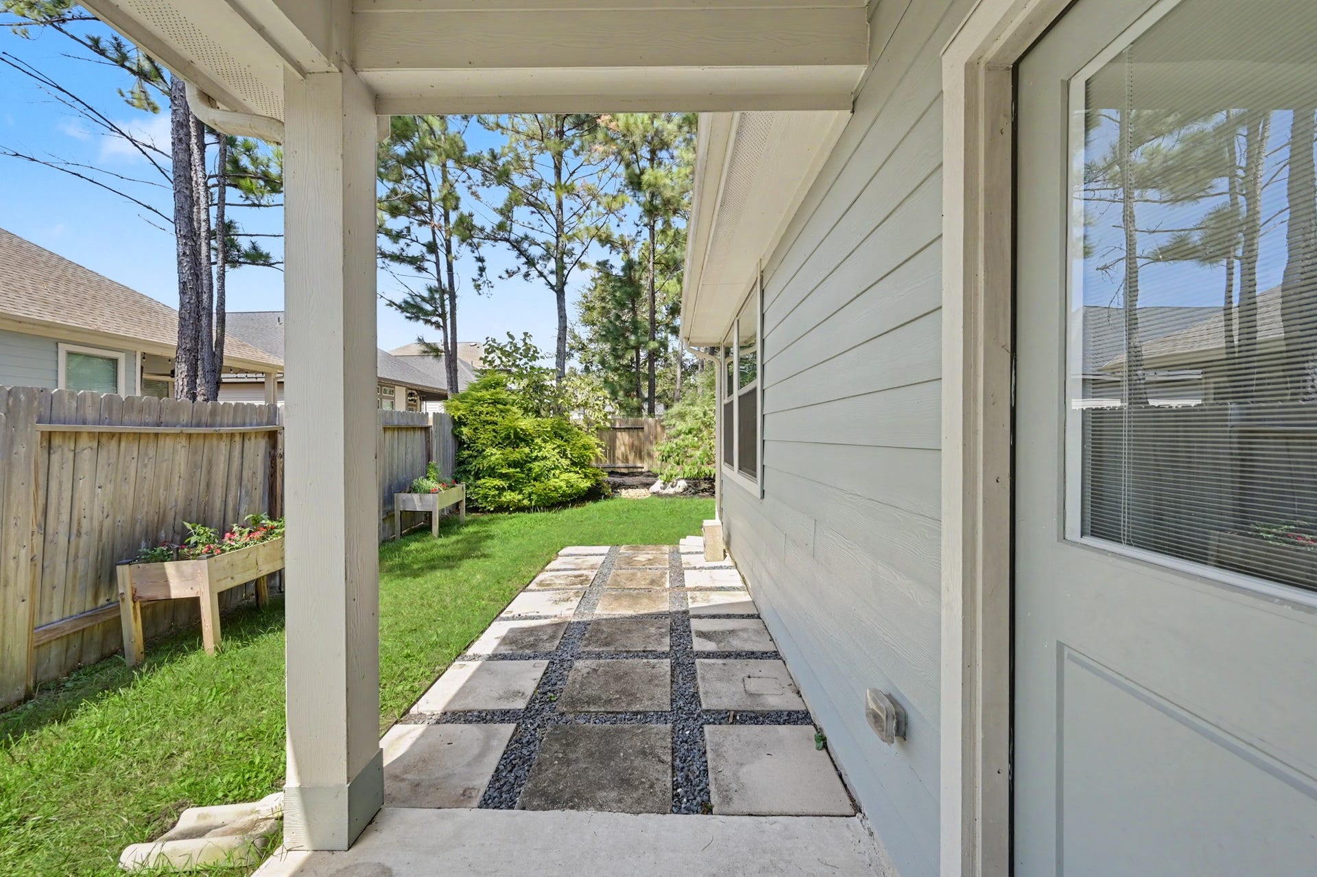 Cute covered porch leading to back yard