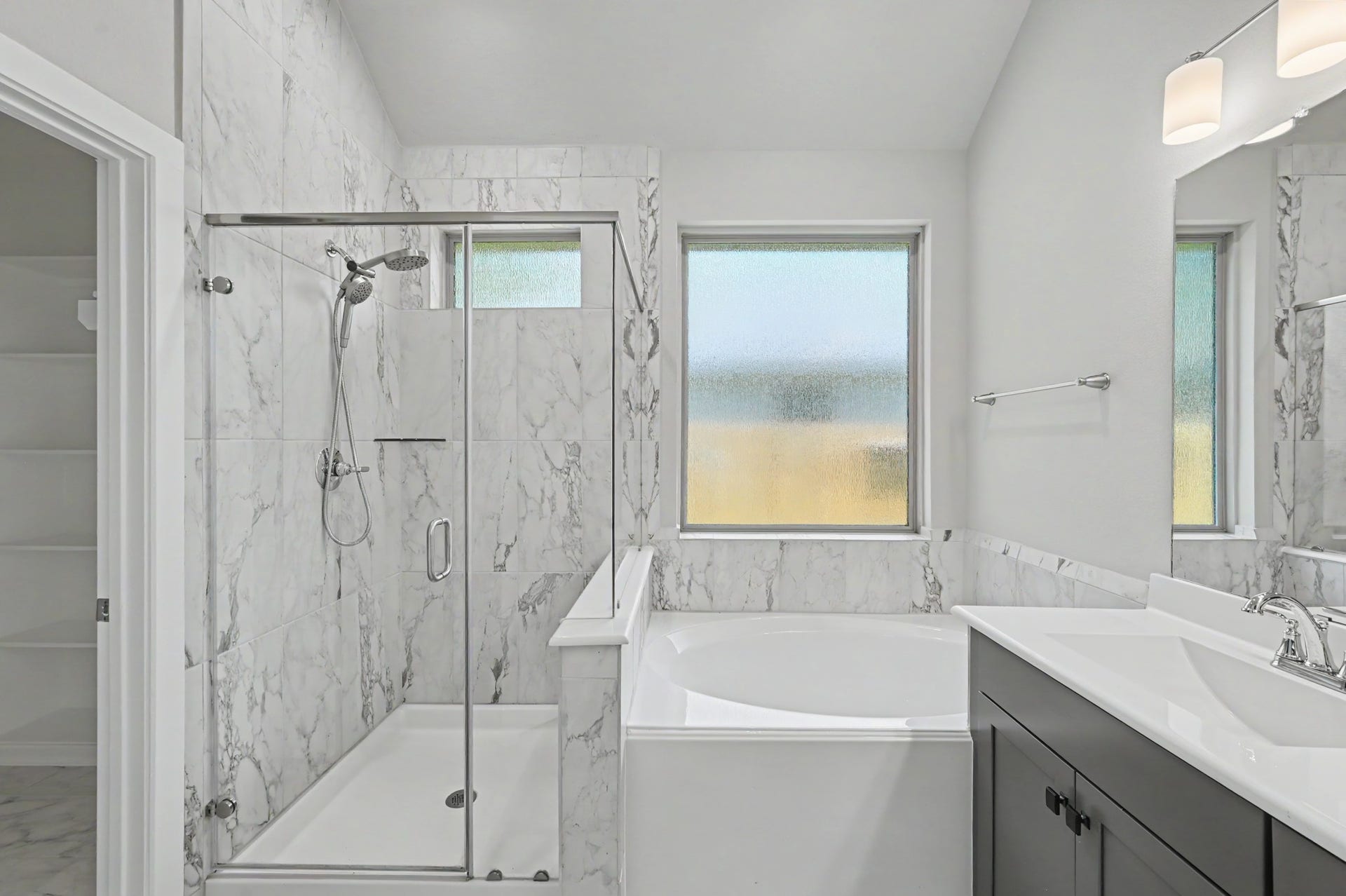 Melt away the days stress in your large soaking tub. Oversized glass shower w/ cute window nook.