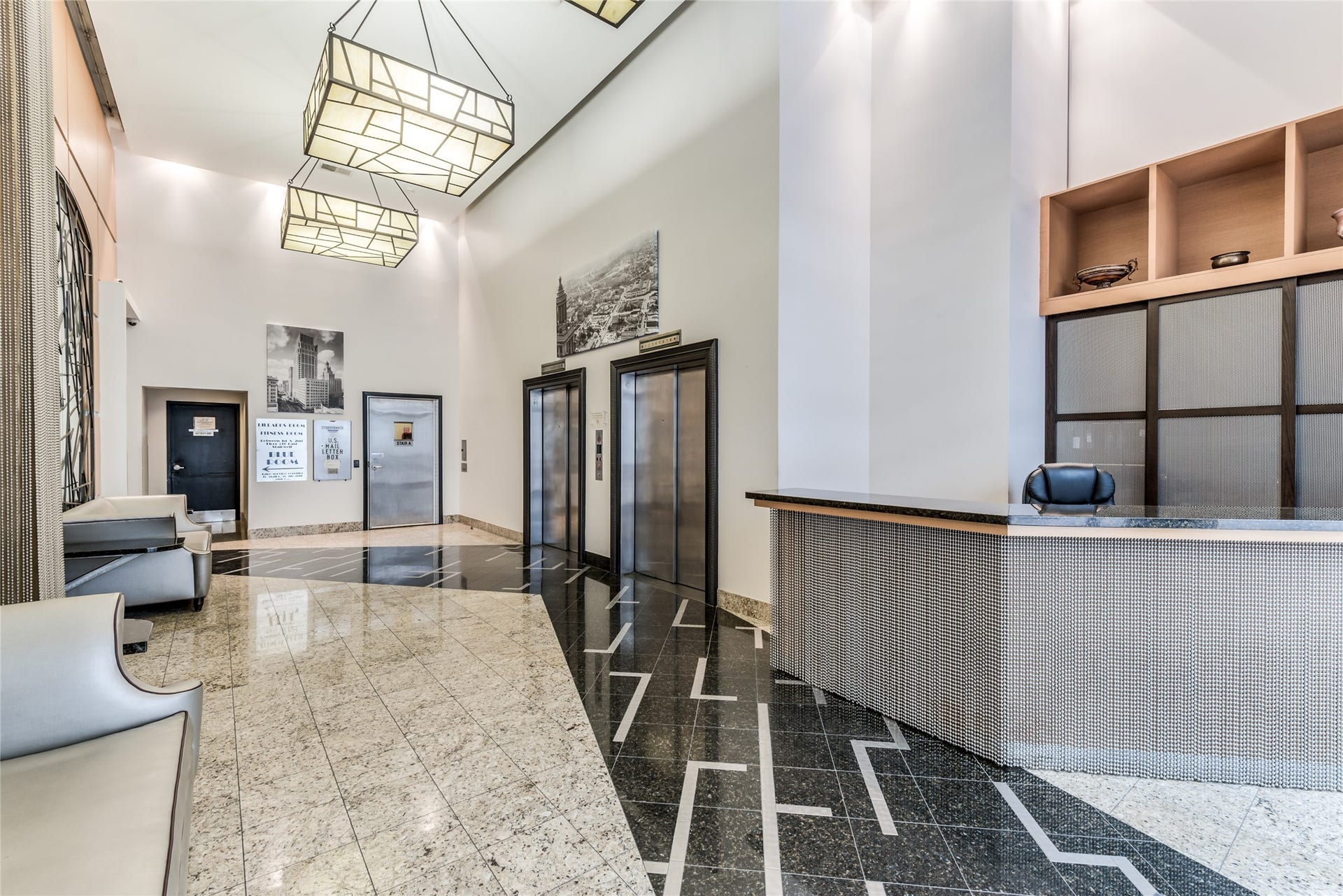 705 Main Street, #215, Houston, TX 77002 Well-lit lobby featuring sleek granite flooring, contemporary lighting fixtures, and a stylish concierge desk.