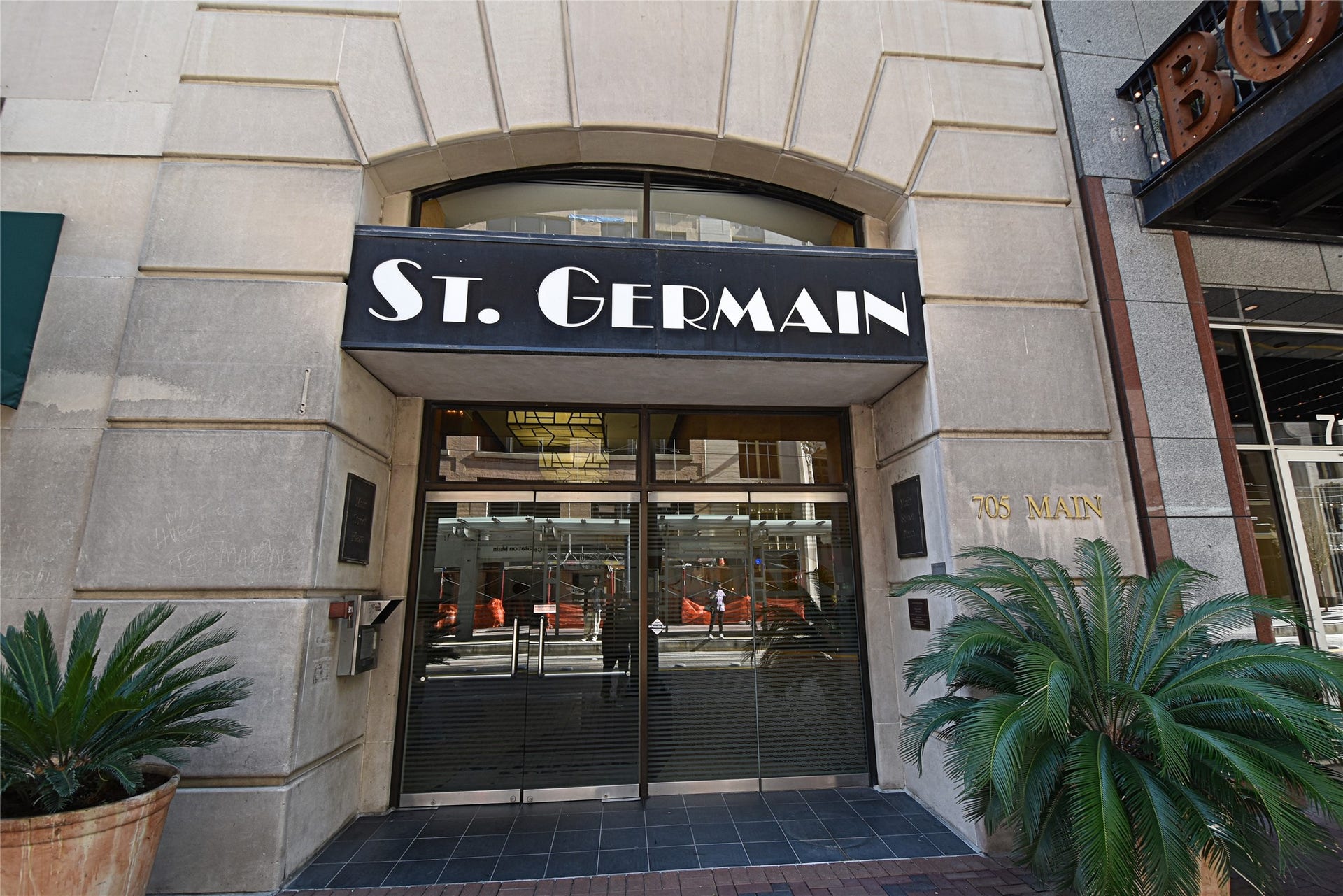 705 Main Street, #215, Houston, TX 77002 Tthe entrance to the St. Germain building, featuring a modern facade with large glass doors and a prominent sign.