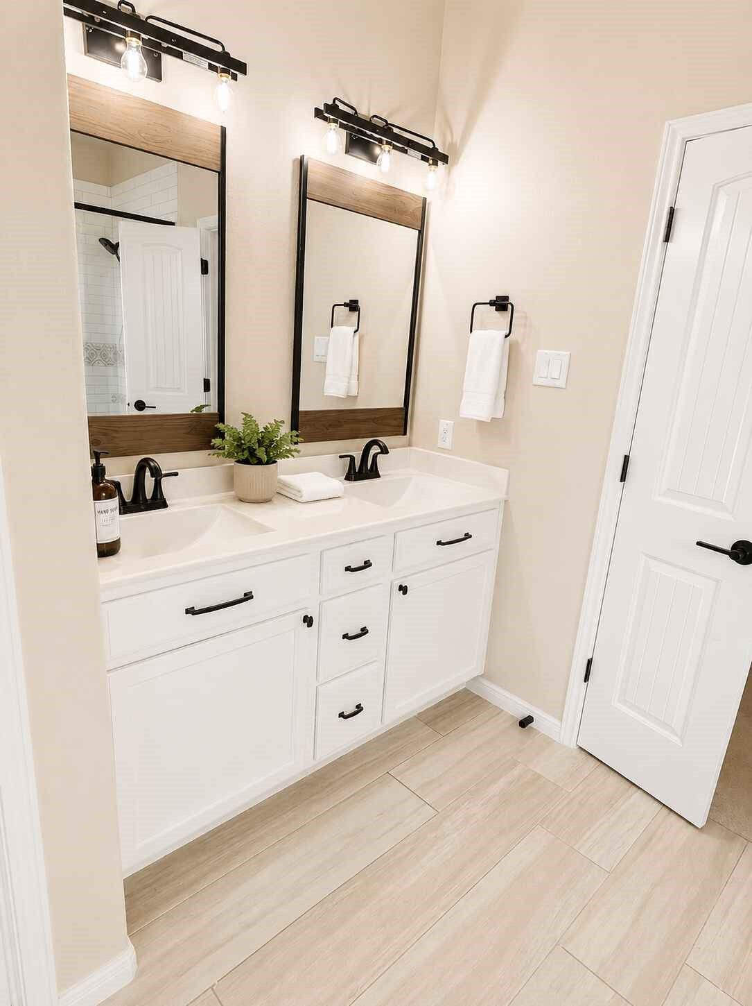 21570 Spear Valley Lane, Porter, TX 77365 Beautifully updated primary bath features a dual-sink vanity, modern black fixtures, stylish lighting and plenty of cabinet storage for a clean, polished look