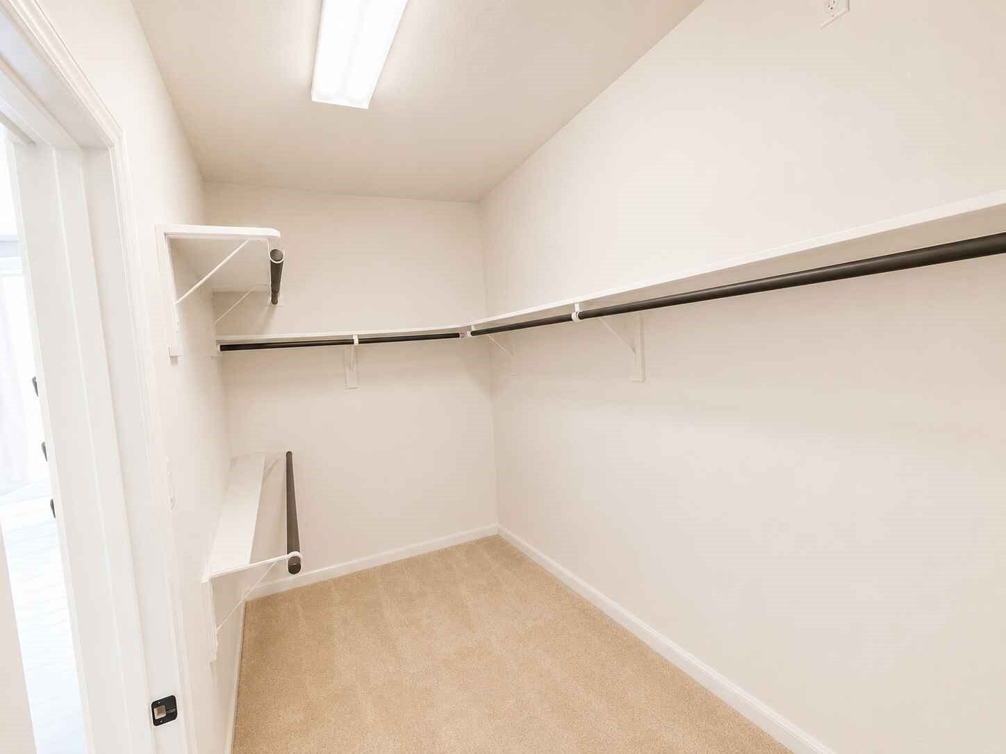 21570 Spear Valley Lane, Porter, TX 77365 Spacious walk-in primary closet offers plenty of hanging space and built-in shelving to keep clothing, shoes and accessories organized