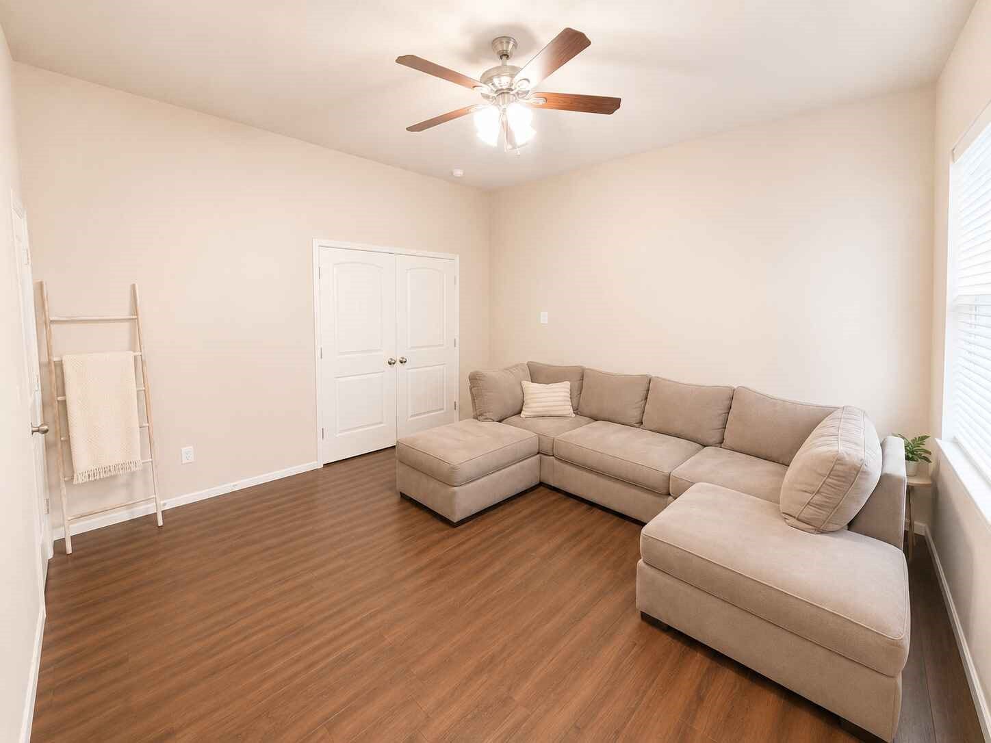21570 Spear Valley Lane, Porter, TX 77365 Versatile bonus room offers generous space for a game room, media room, home office or second living area, with warm wood-look flooring, natural light and a ceiling fan