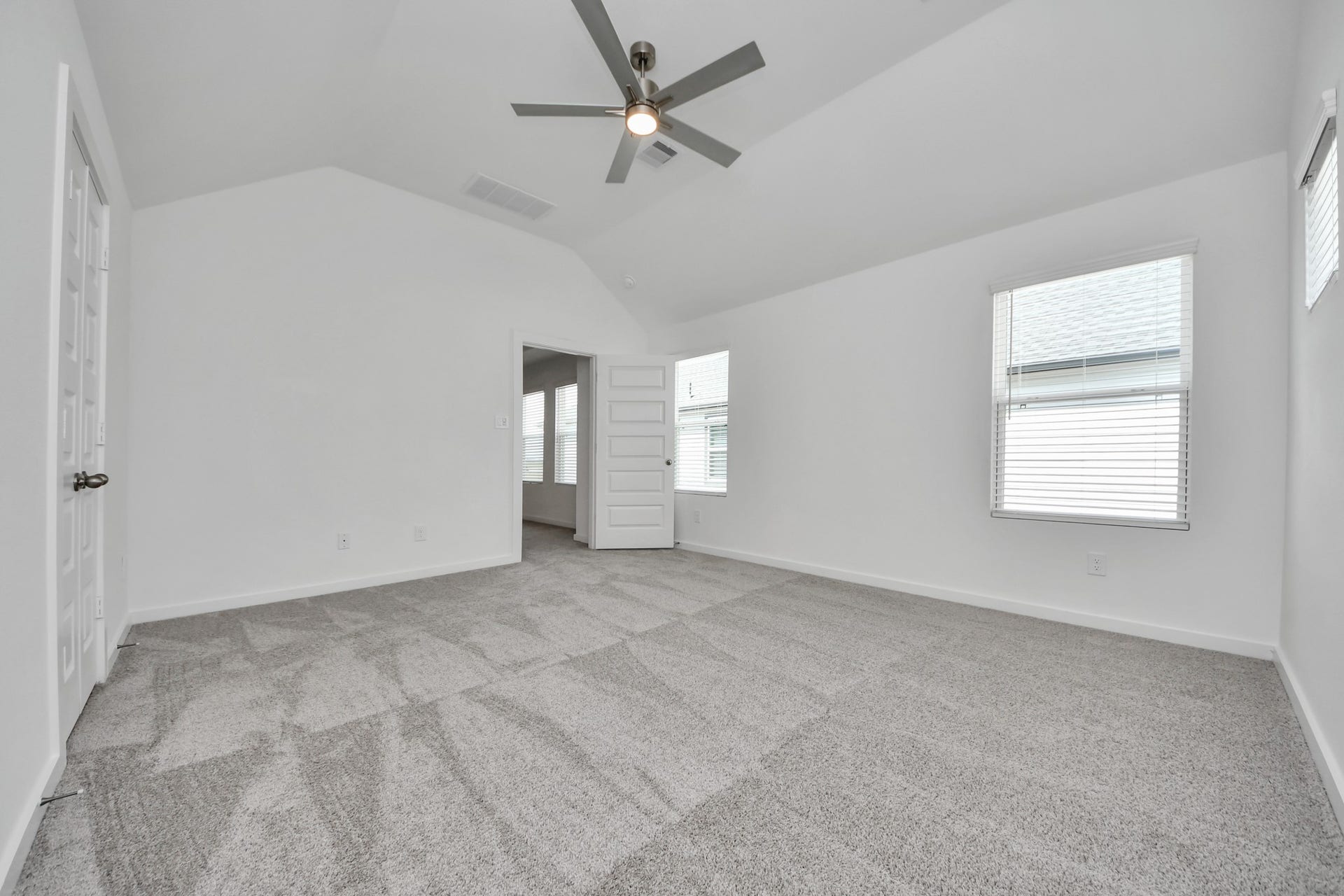 14919 Diamond Dove Lane, Houston, TX 77049 Come and unwind after a long day in this magnificent primary suite! This spacious room features plush carpet, warm paint, high ceilings and large windows with privacy blinds. Sample photo of completed home with similar floor plan. Actual colors and selections may vary.