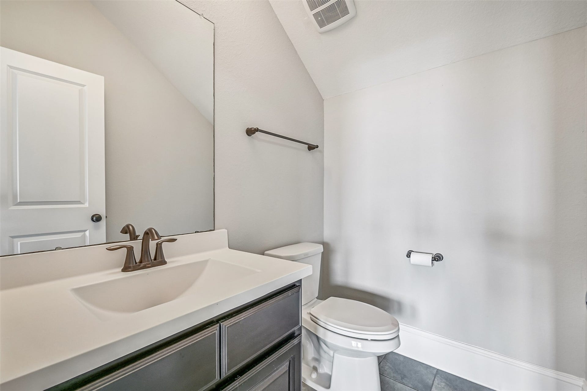 A convenient half bath serves the third-floor media room, allowing this entire level to function as a private entertainment retreat without trips downstairs.