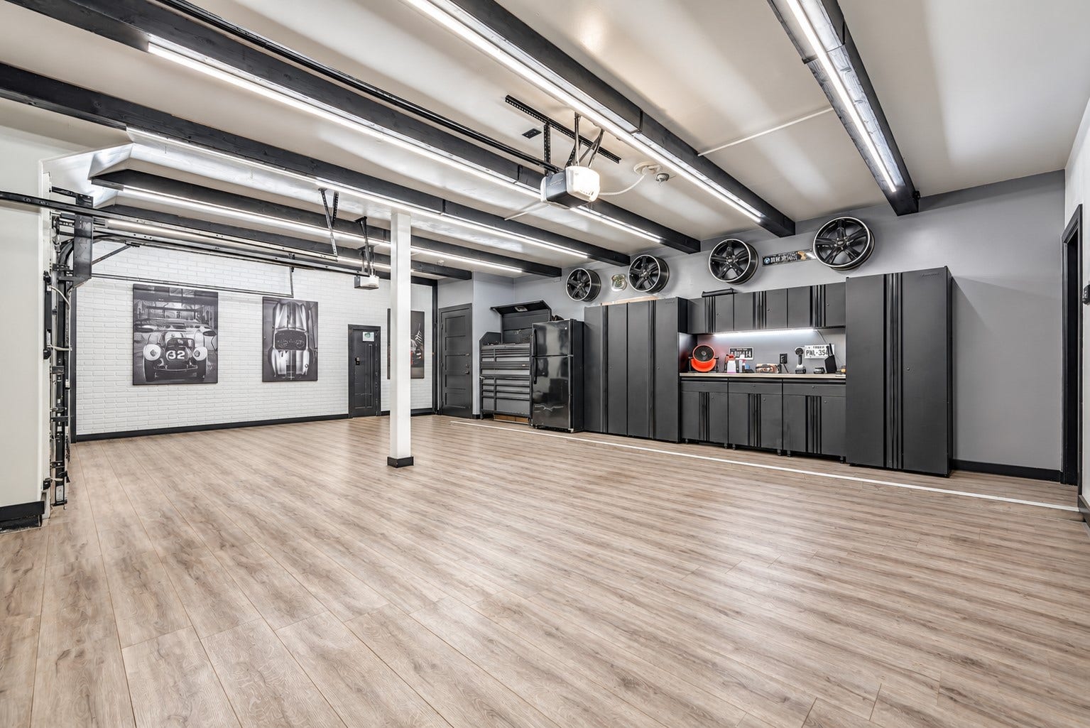 Even the garage is impressively finished, with wood-look plank flooring, extensive LED lighting and a full wall of workshop cabinetry with countertop and abundant storage. Additional storage closet and garage refrigerator add even more function.
