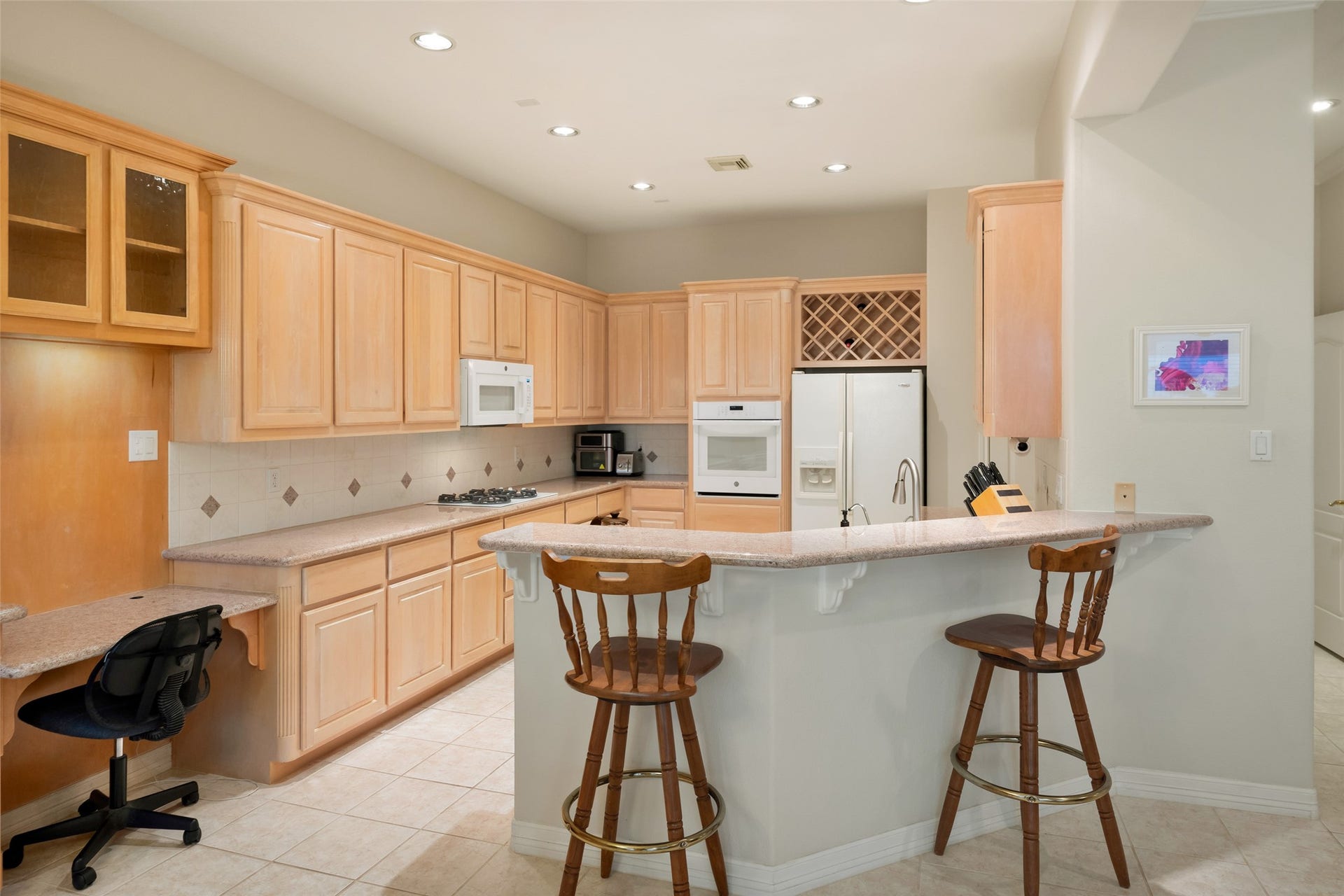 Need to do a little work?  Boot up your computer in the desk area at the end of the custom cabinets.