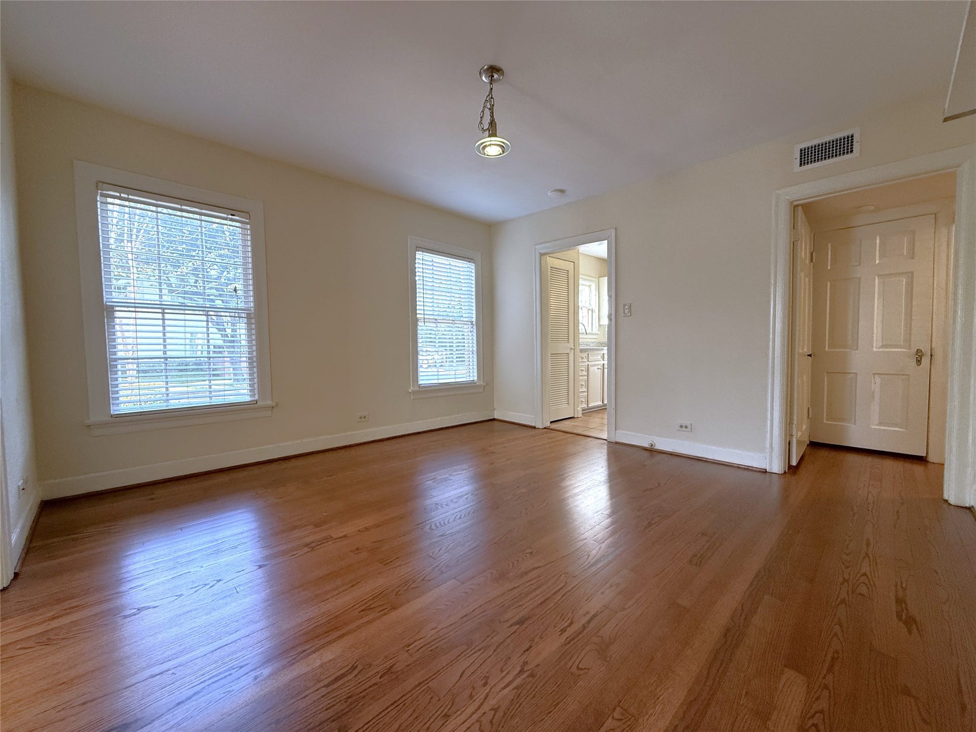 1968 Dryden Road, #1, Houston, TX 77030 Alternate view of the dining room, natural light flows in from twin windows. A privacy door opens into the hallway leading to the bedrooms and baths.