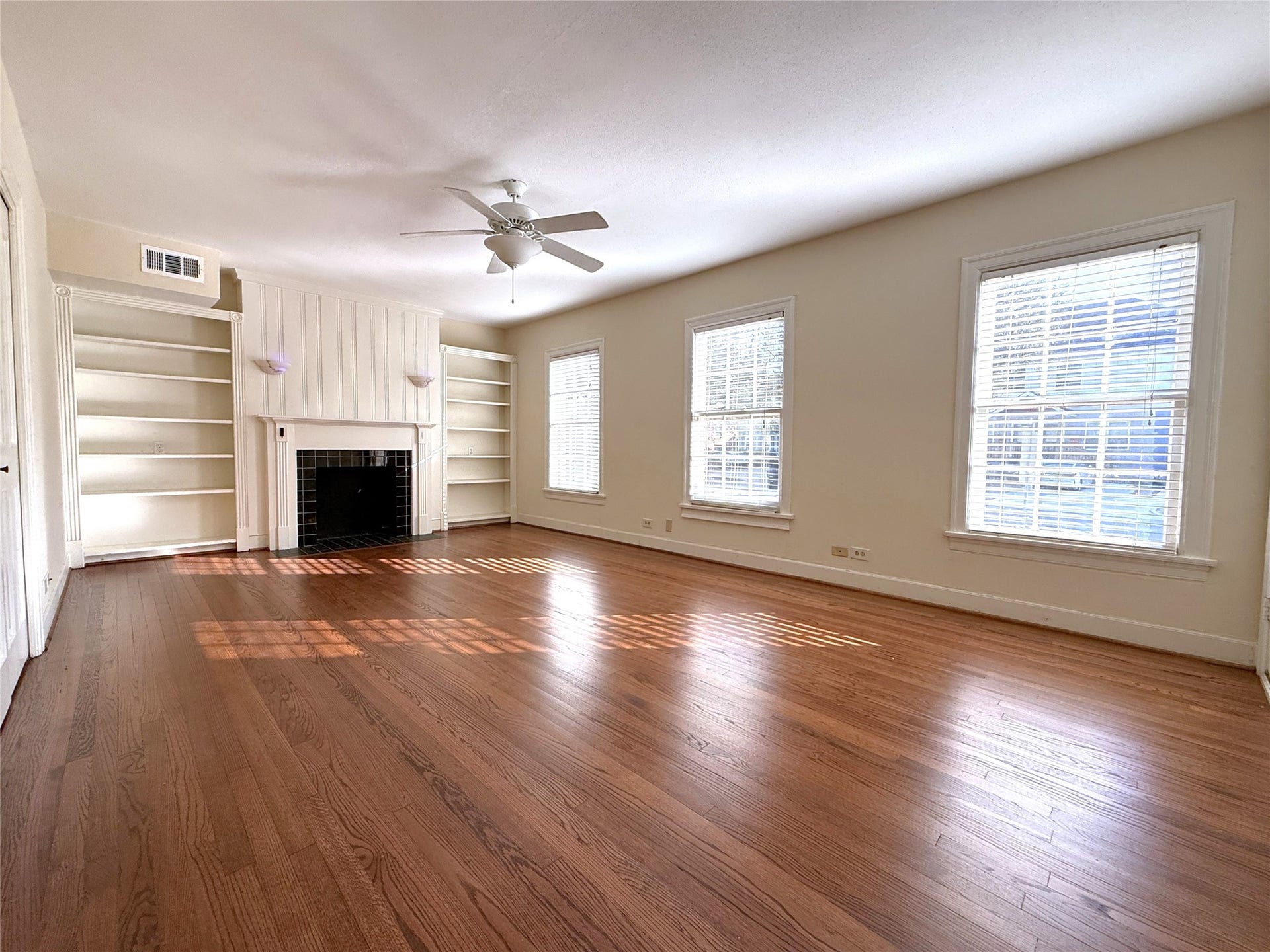 1968 Dryden Road, #1, Houston, TX 77030 Welcome home! The living room offers a ceiling fan w/light fixture, mock fireplace, built-in shelving & sconce lighting. Natural light flows in from tri windows.