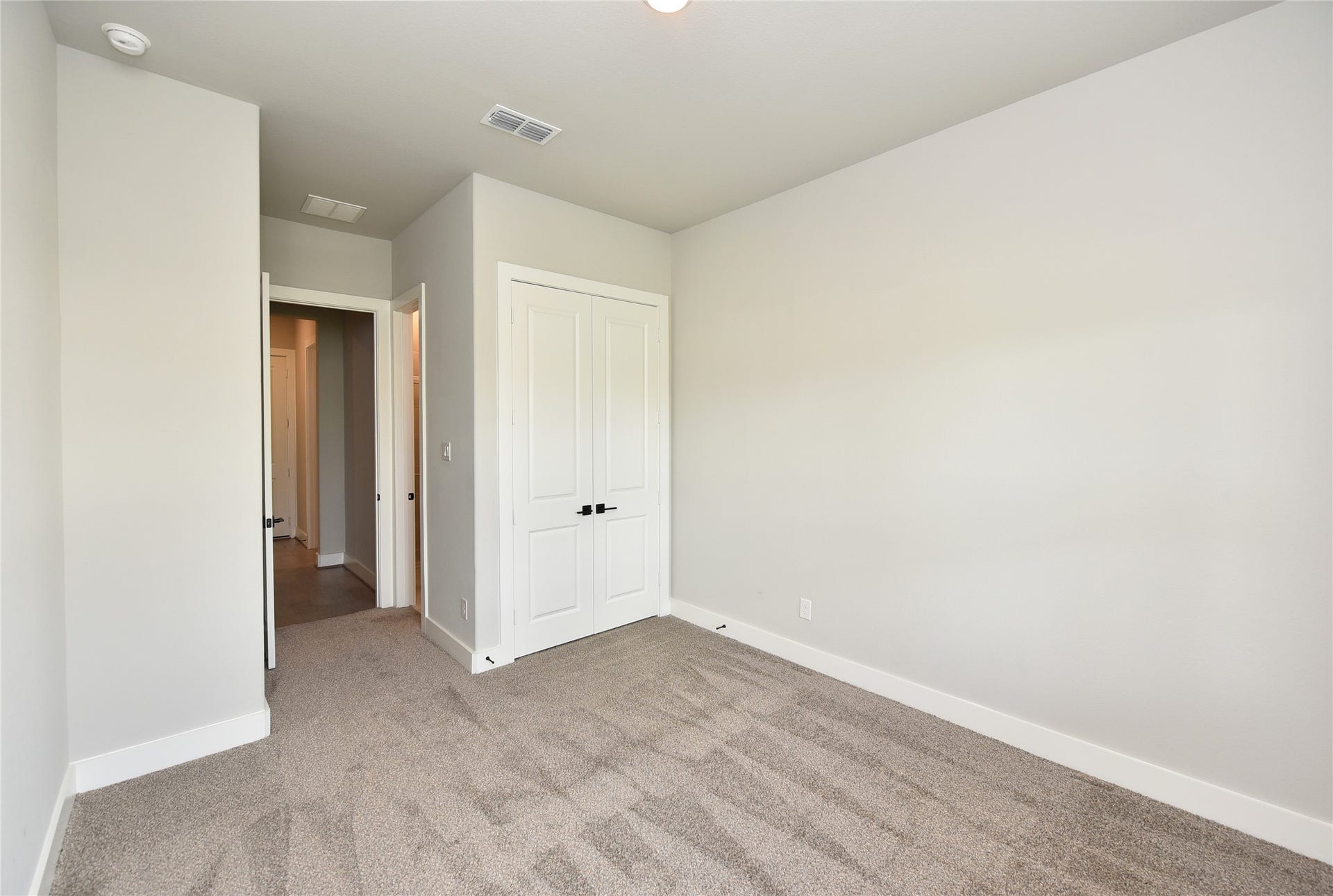 The second downstairs bedroom is perfect for an extended family member or nanny.  Is located on far opposite side of home from primary suite.